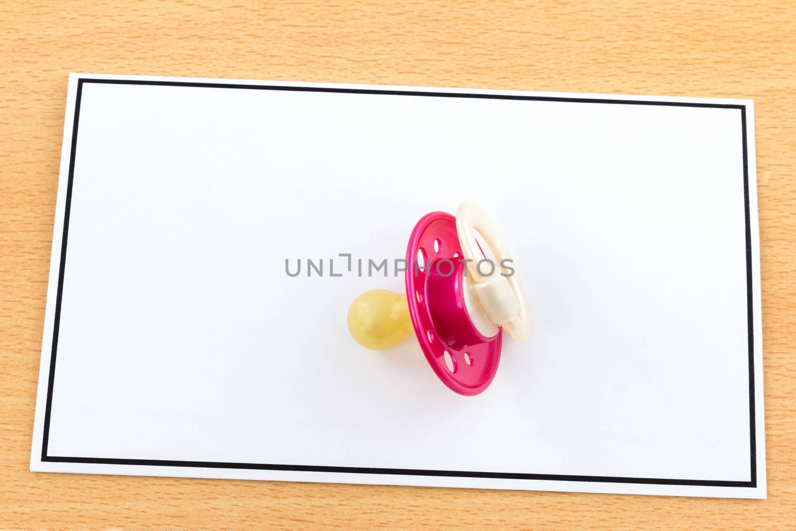Child Mortality, red pacifier on card with black frame