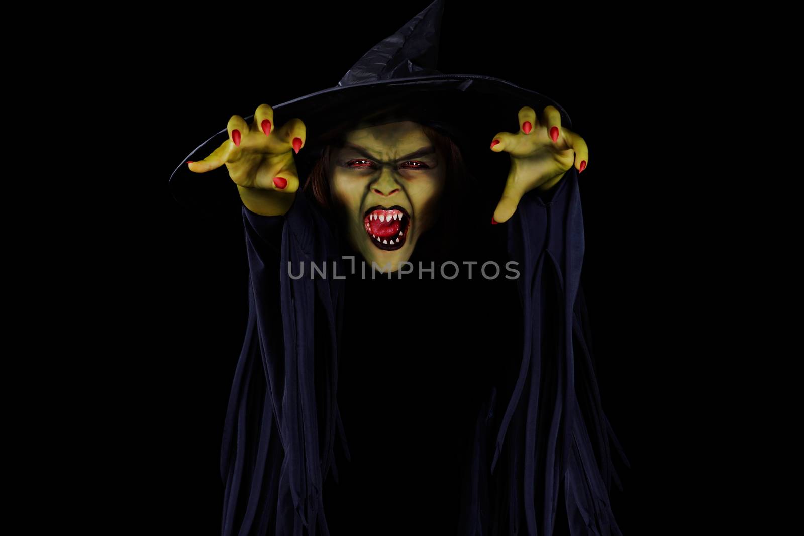 Scary wicked witch trying to catch viewer, Halloween concept