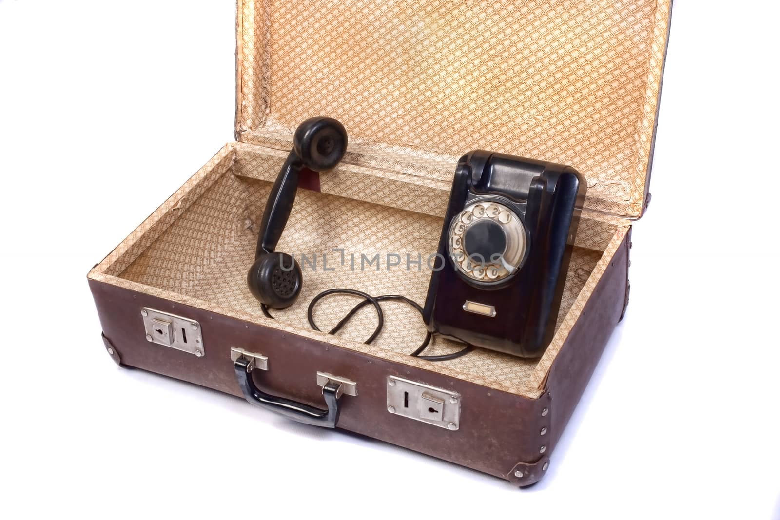 Old rotational phone in old suitcase