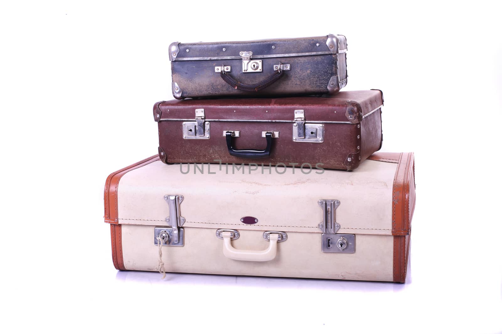 Three old suitcases on white background