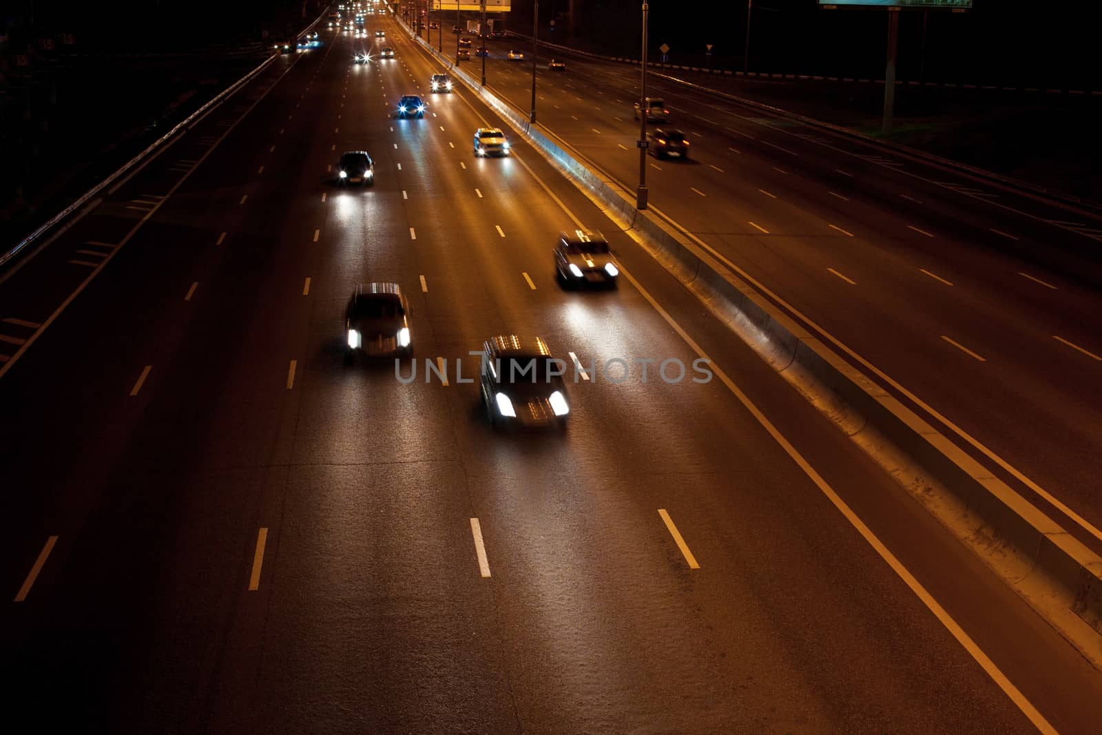 Cars going night on wide motorway