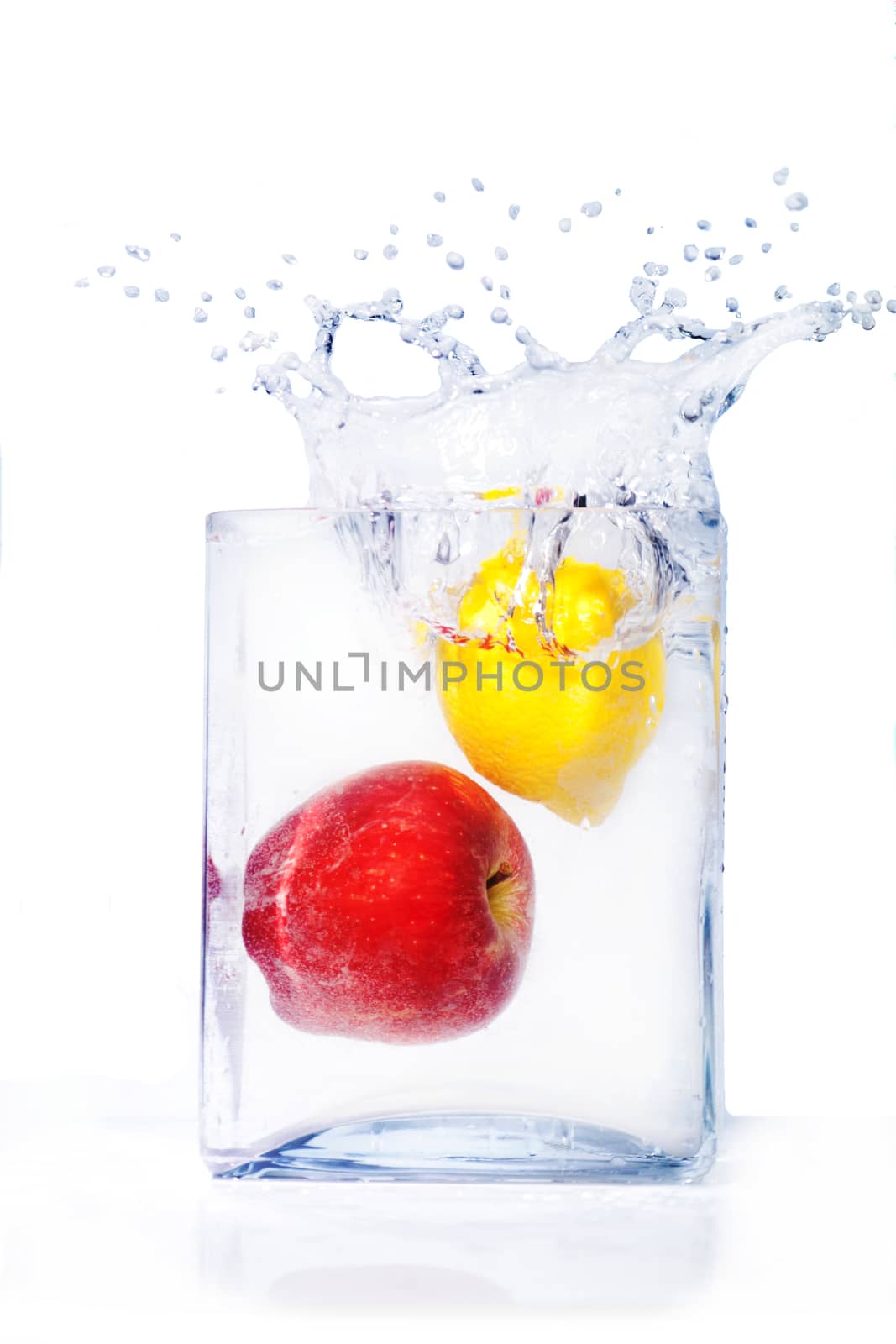  apple and lemon in water and splashes is isolated