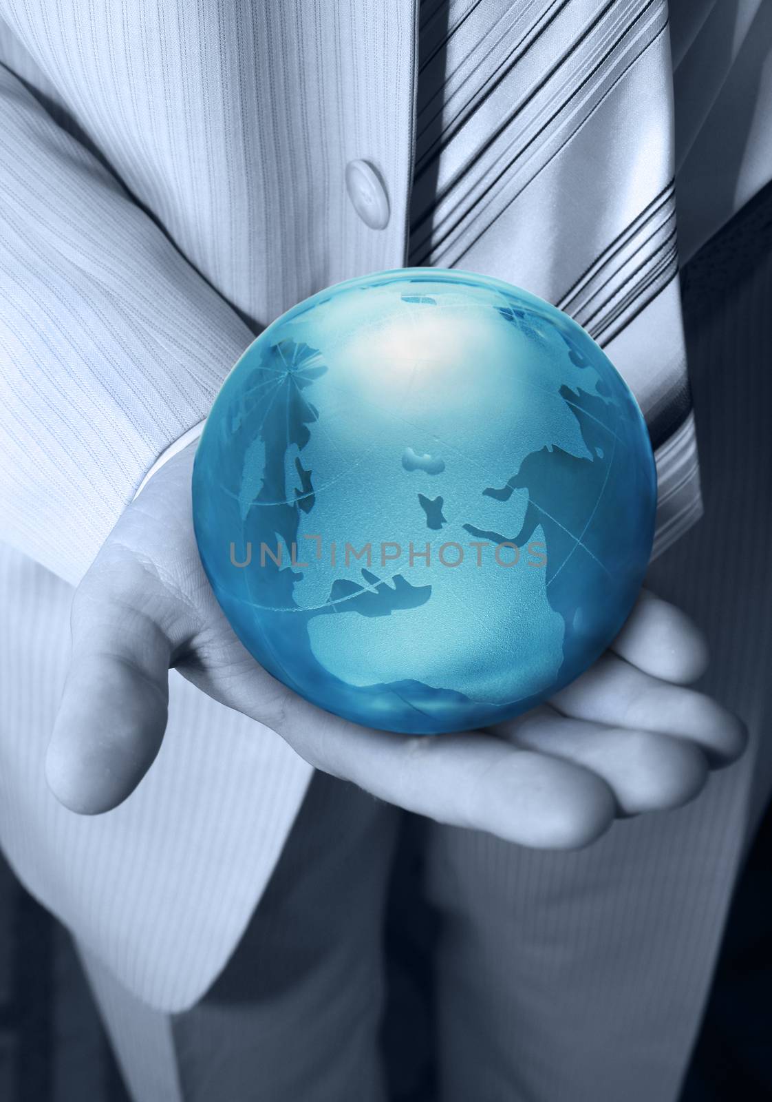 Globe glass blue in hands at the businessman