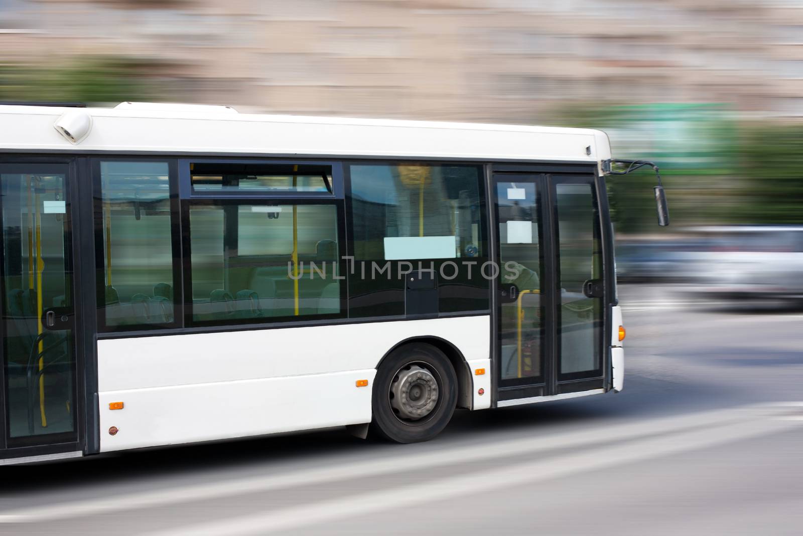 white city bus goes along street