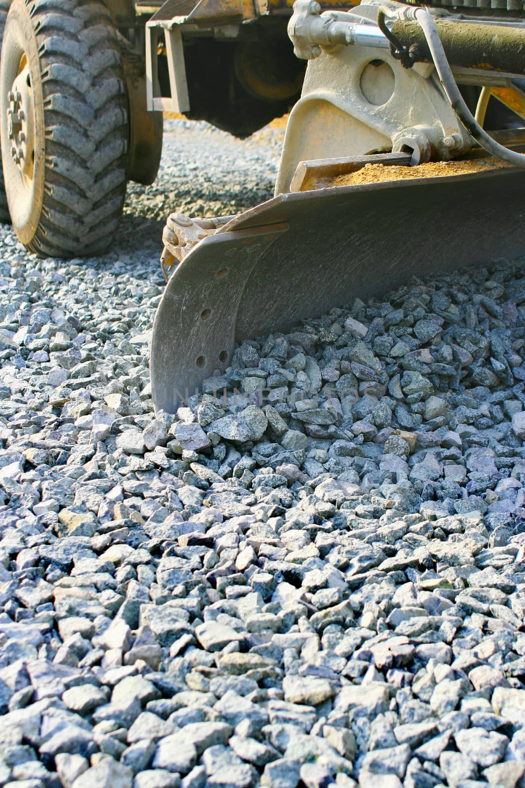  grader levels rubble on  basis of  road cloth