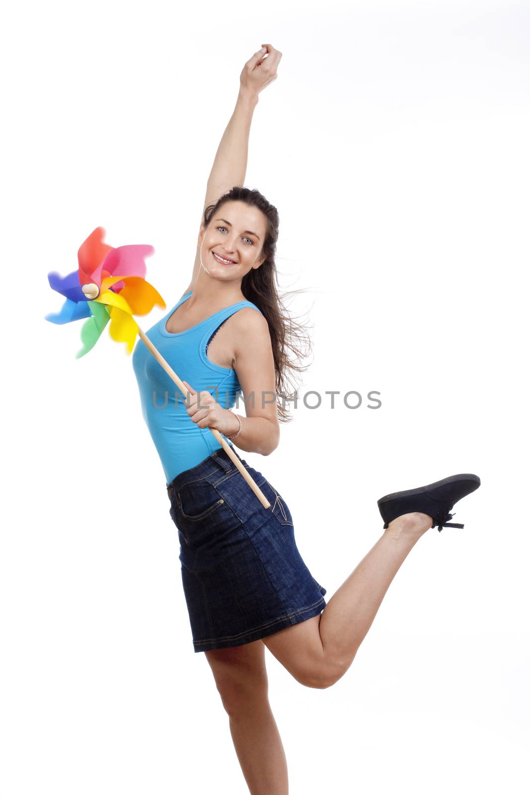 beautiful young woman holding a multicolored pinwheel - isolated on white