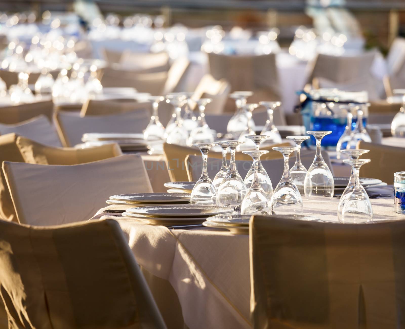 Table setting for an event party at outdoor cafe in the evening light