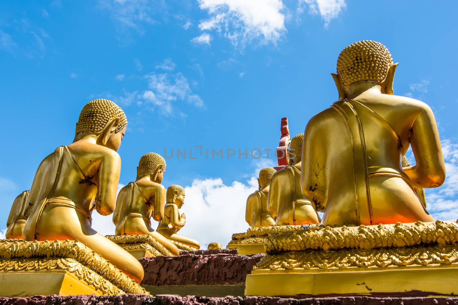 the group of golden buddhas at Thai temple in Thailand