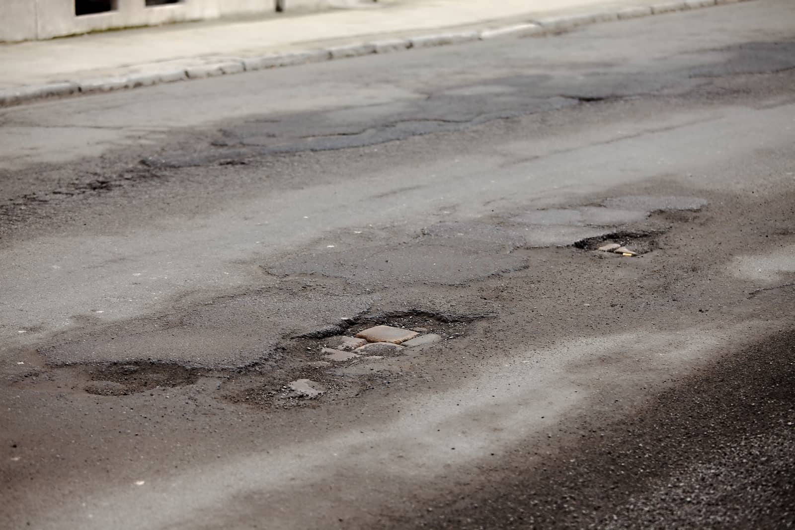 Very bad quality road with potholes