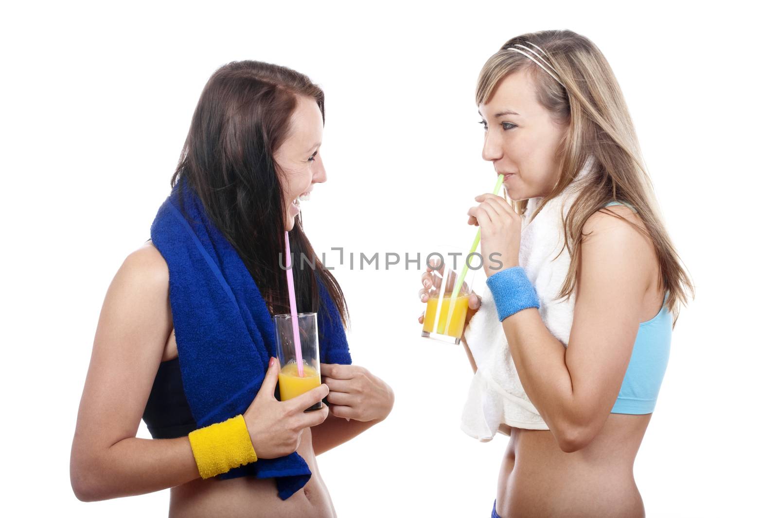 young woman in sports outfit drinking juice, talking - isolated on white