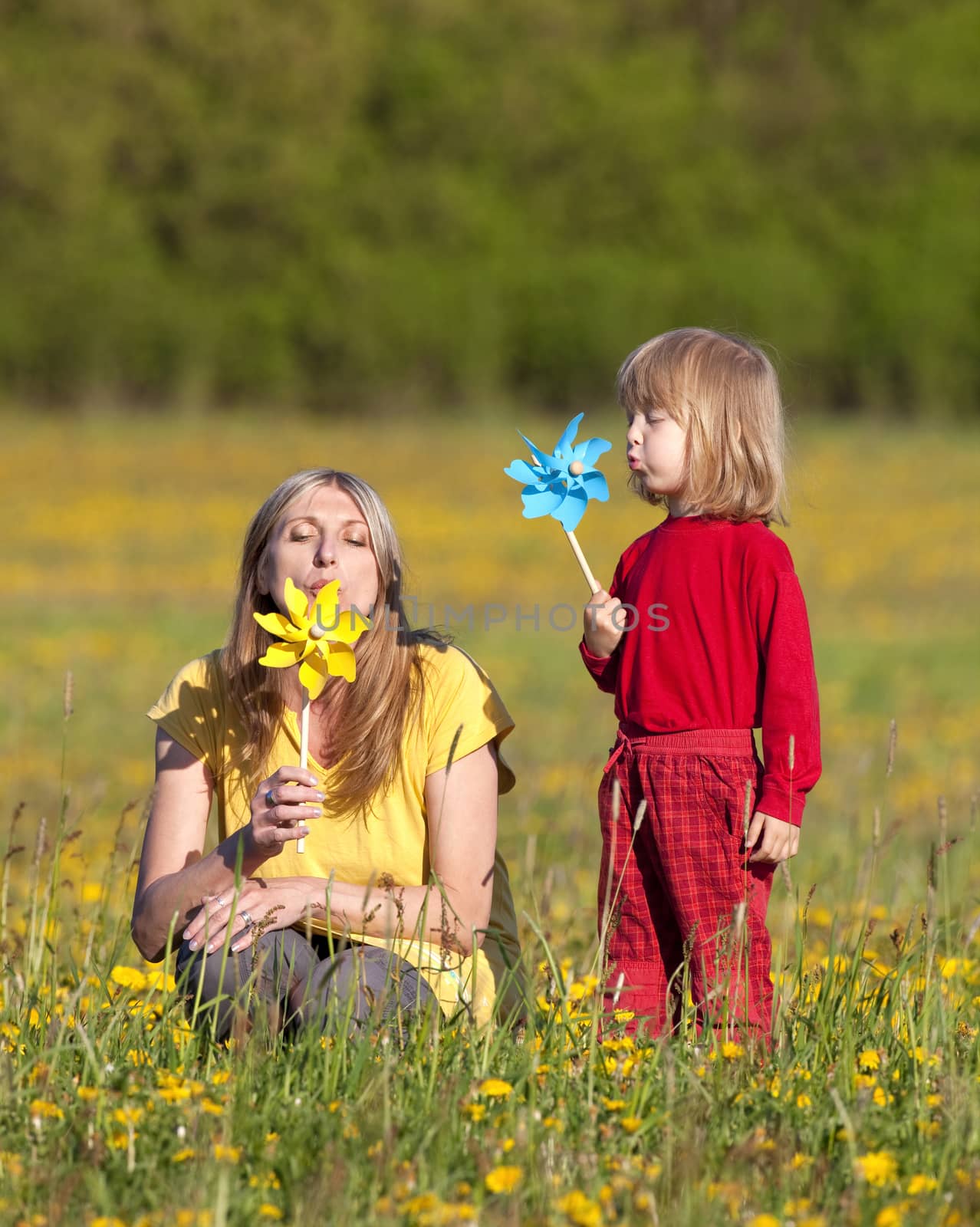 mother and son with pinwheels by courtyardpix