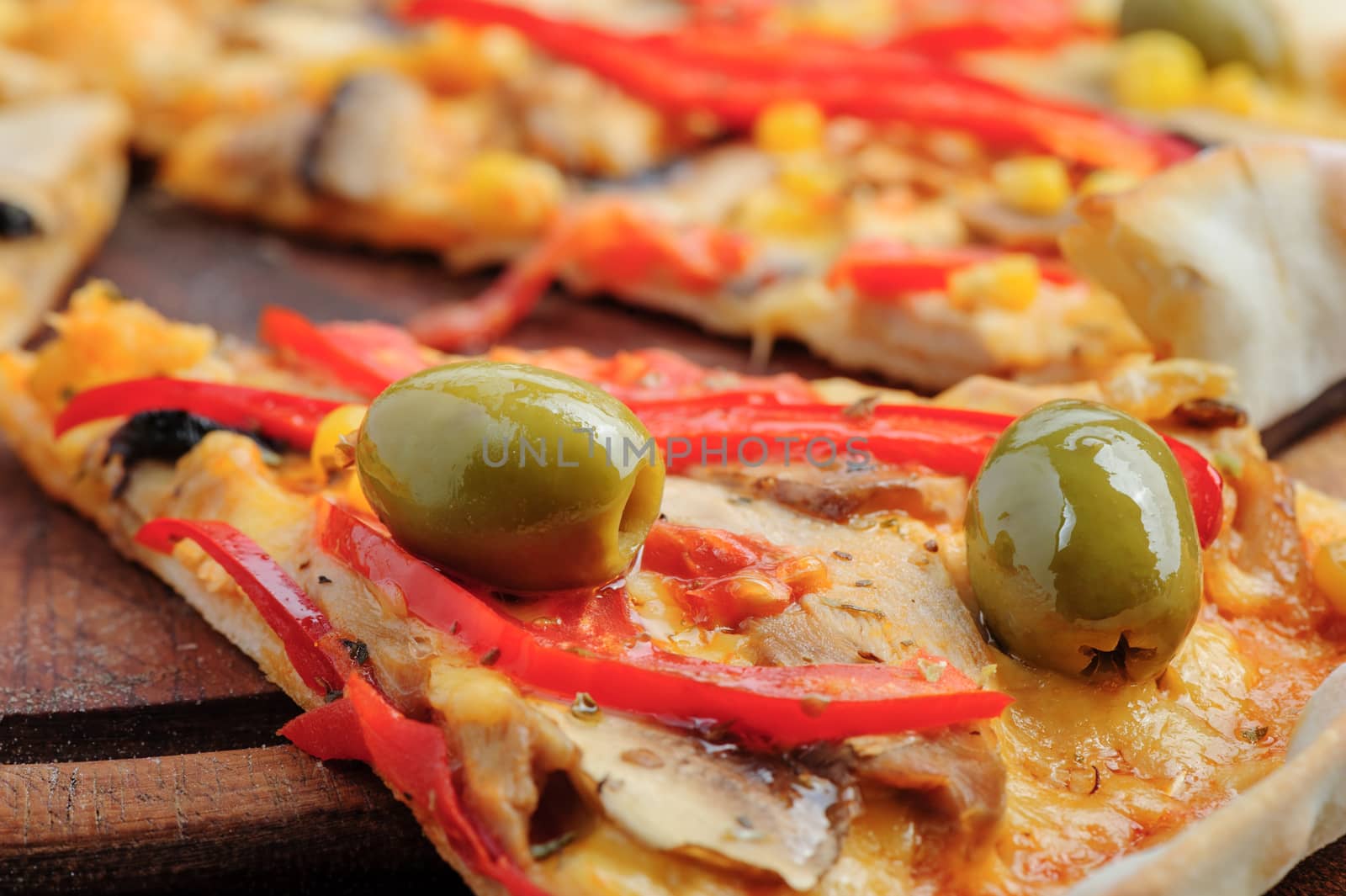 MAcro closeup of pizza with mozzarella, mushrooms, olives and red bell pepper