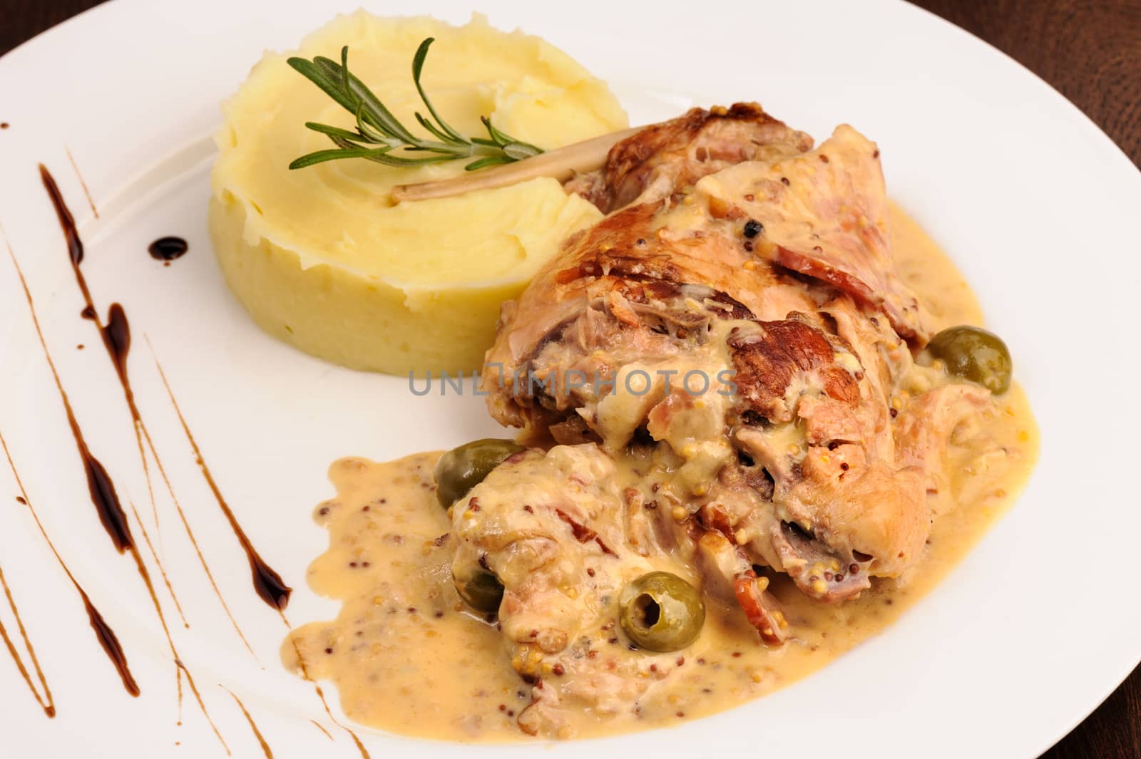 Stewed rabbit legs with potato puree and rosemary