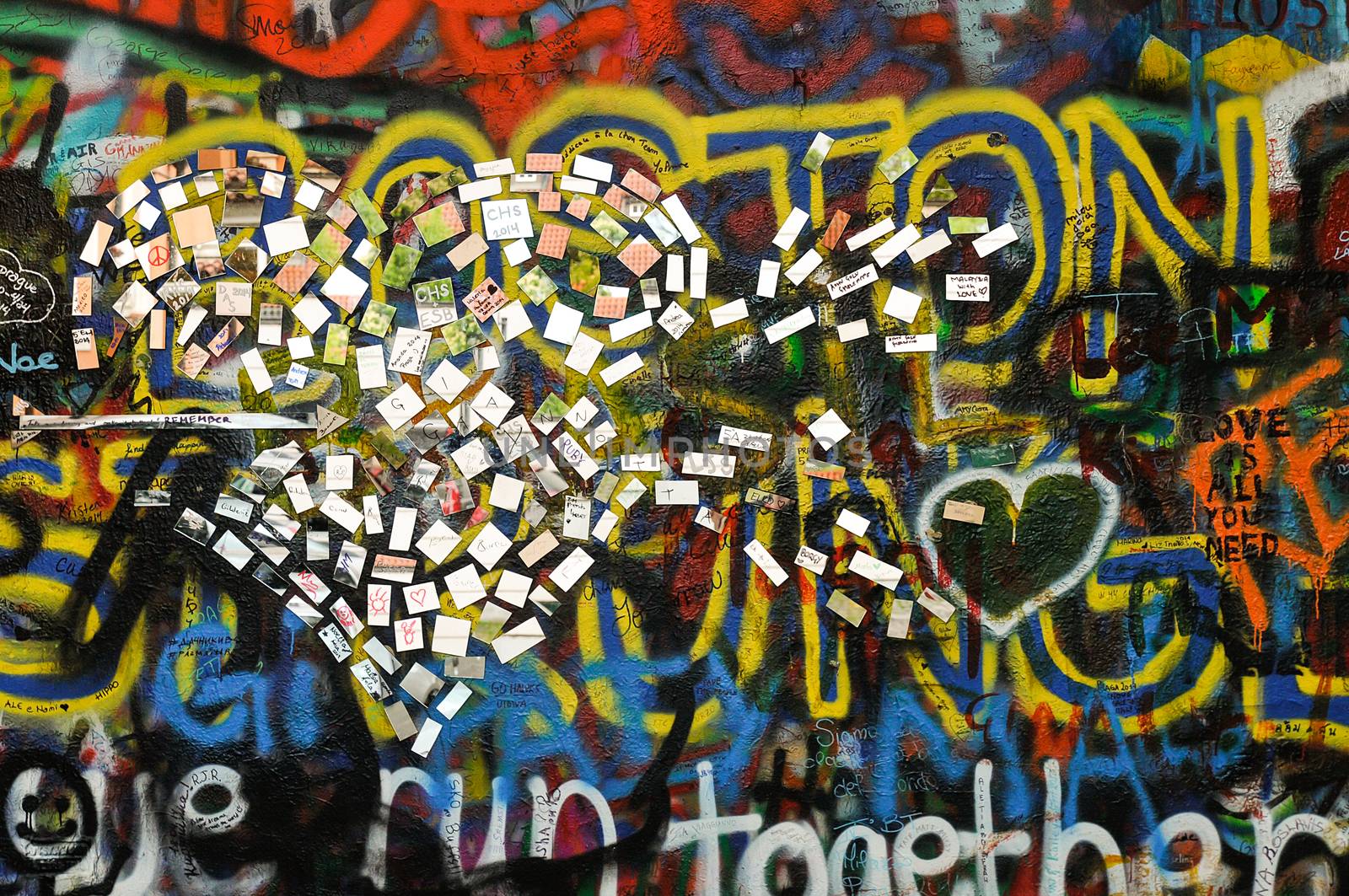 John Lennon Wall in Prague. Wall covered with colorful graffiti and relief made of the mirrors.