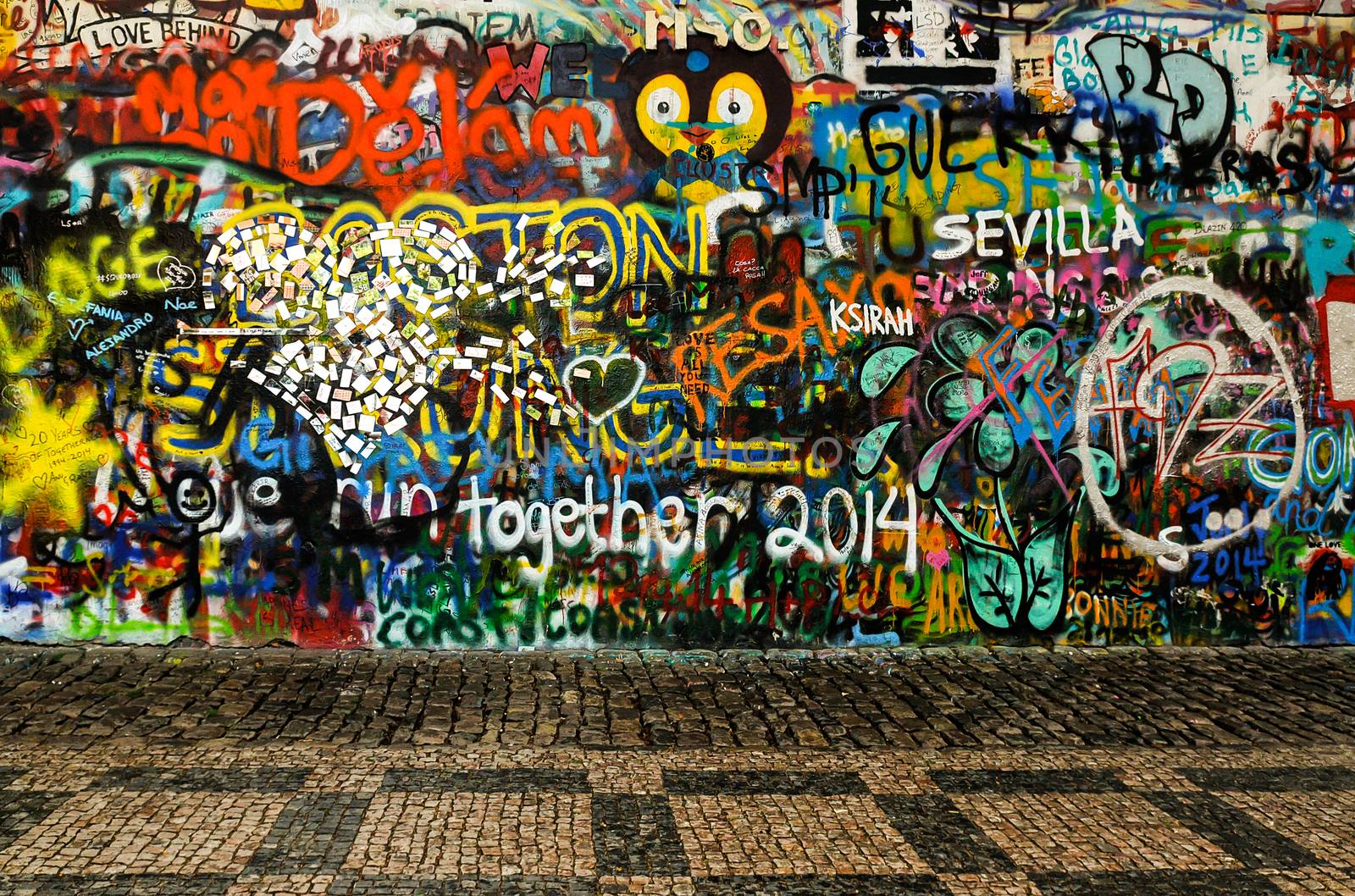 John Lennon Wall in Prague. Wall covered with colorful graffiti and relief made of the mirrors.