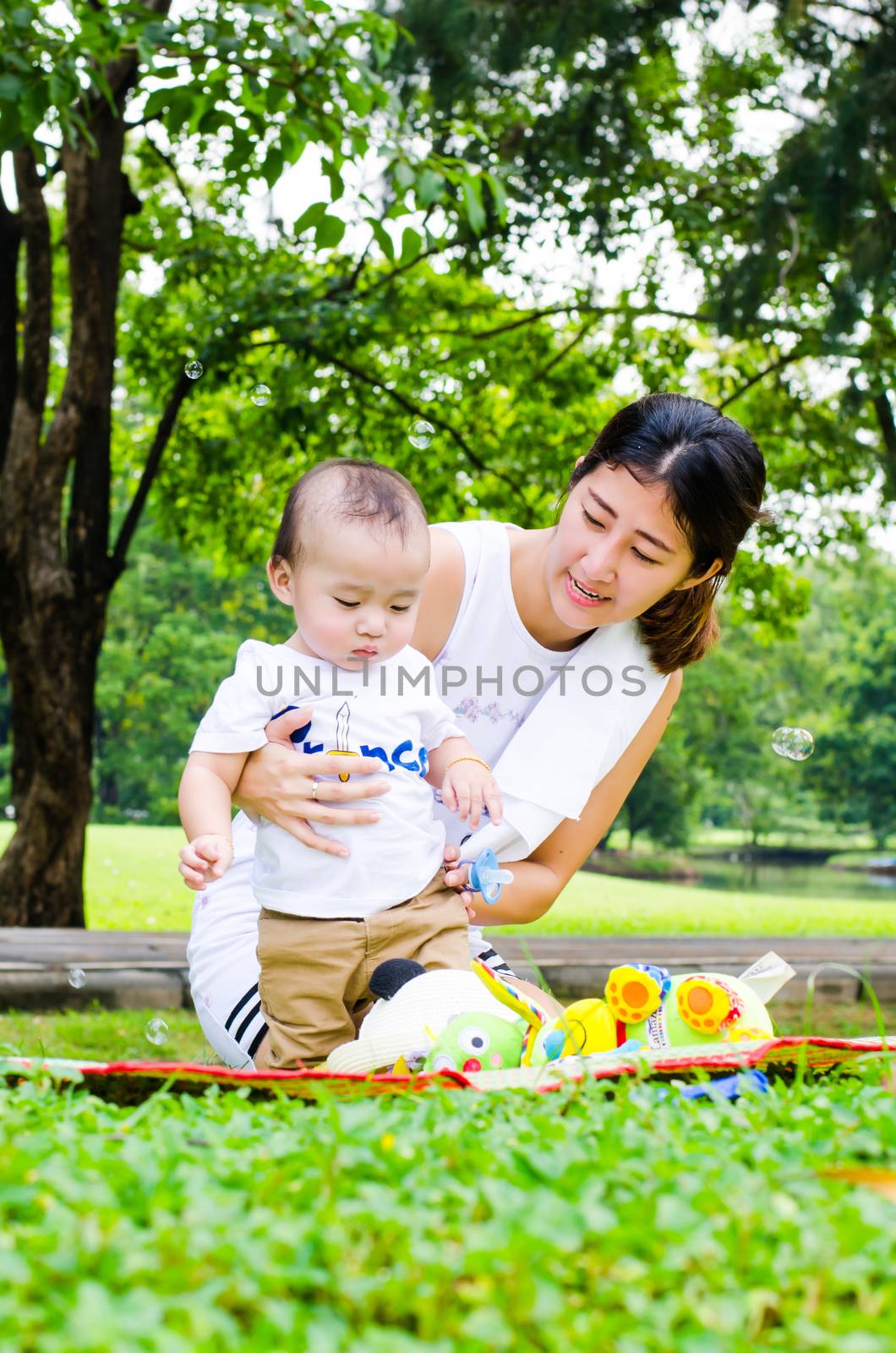 Mother and baby in park, portrait.