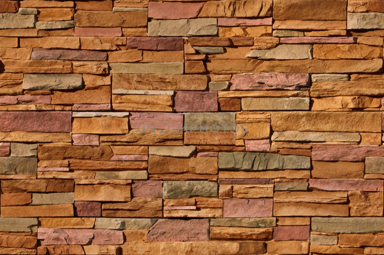 Irregular sized multi-colored bricks with an organic feel. Image is seamlessly tileable