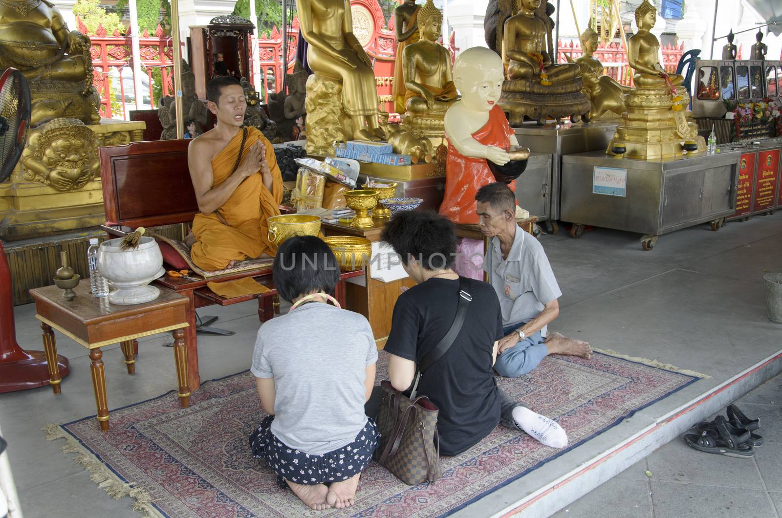 Thai people praying at wat trimit temple Yaowarat Road bangkok thailand 6 July 2014