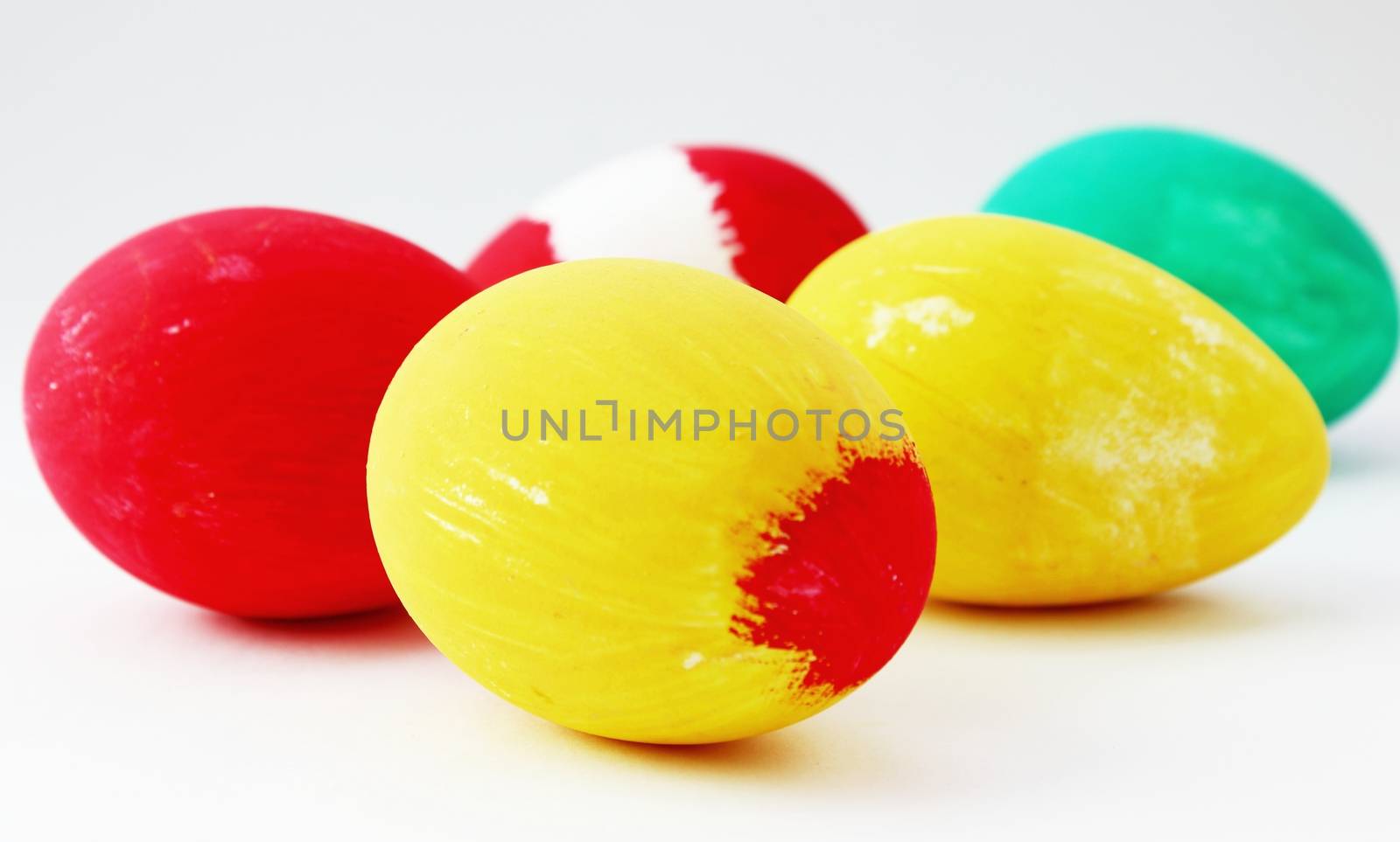 Hand painted Easter eggs isolated on white, in yellow red and green colors. 
