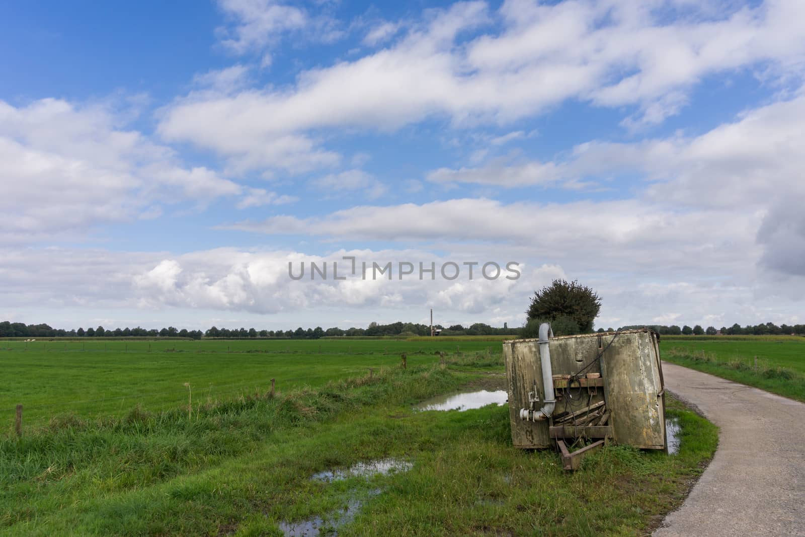 Old abandoned water container on Dutch farmland