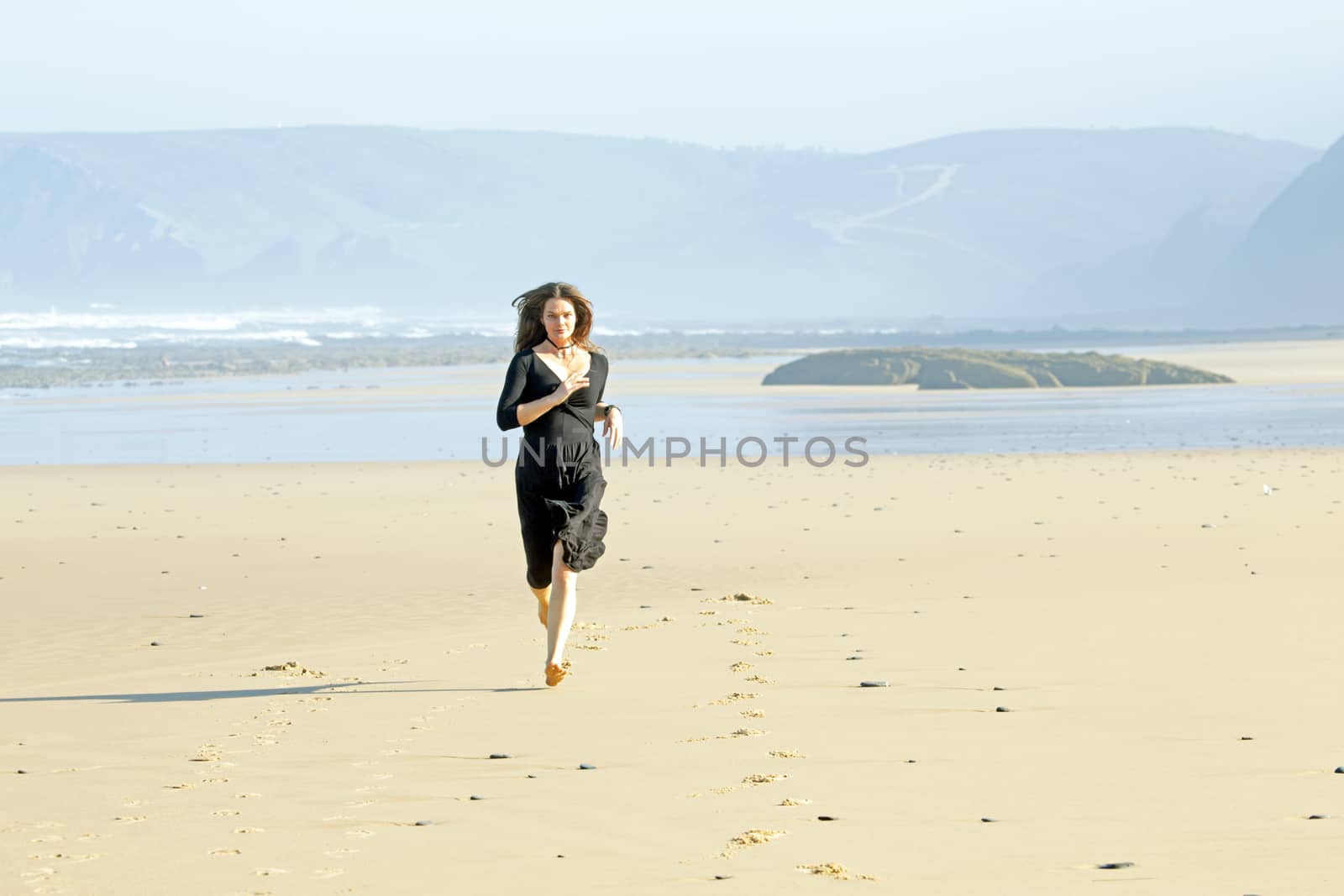 Beautiful woman running at the beach