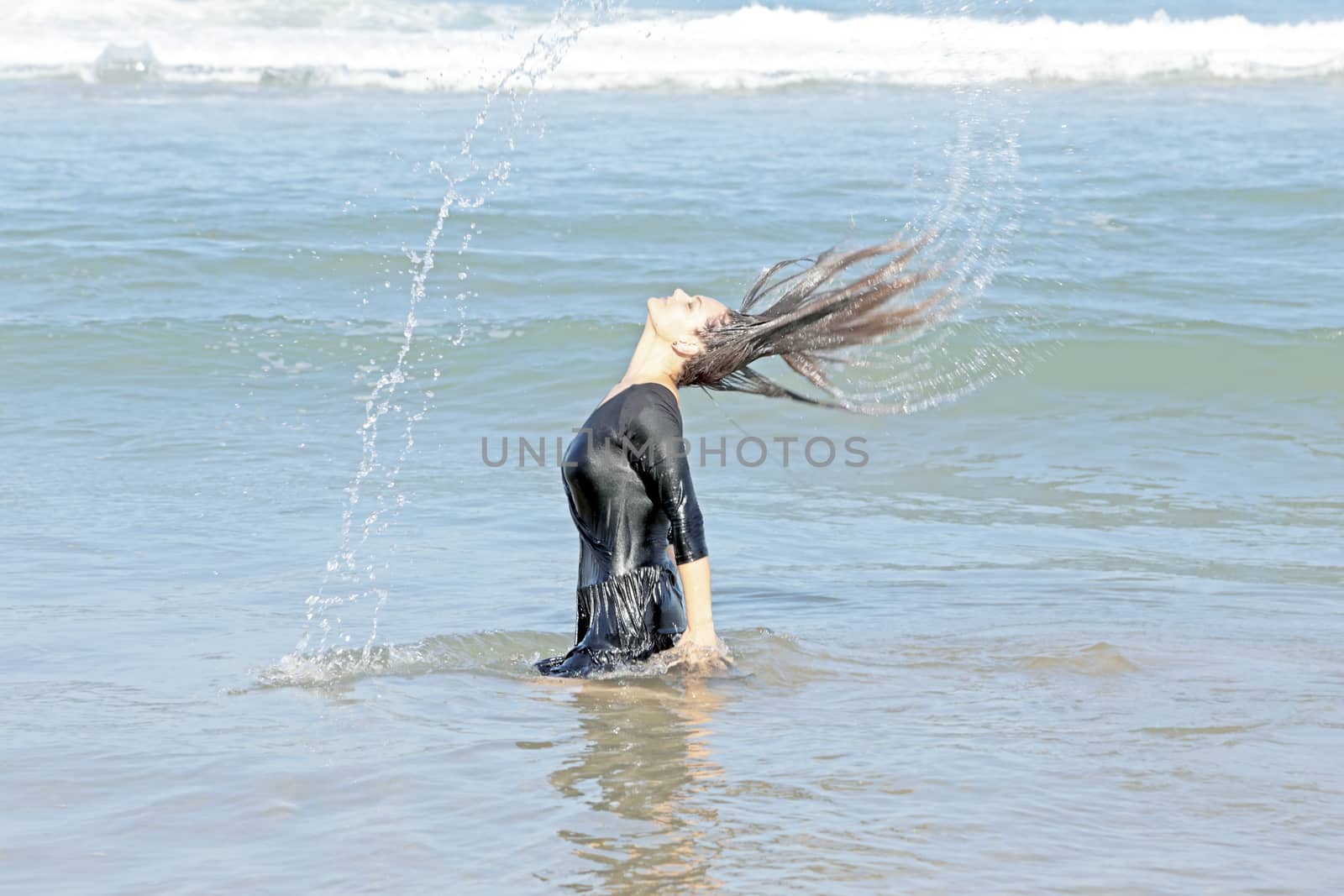 Beautiful woman in the water from the ocean
