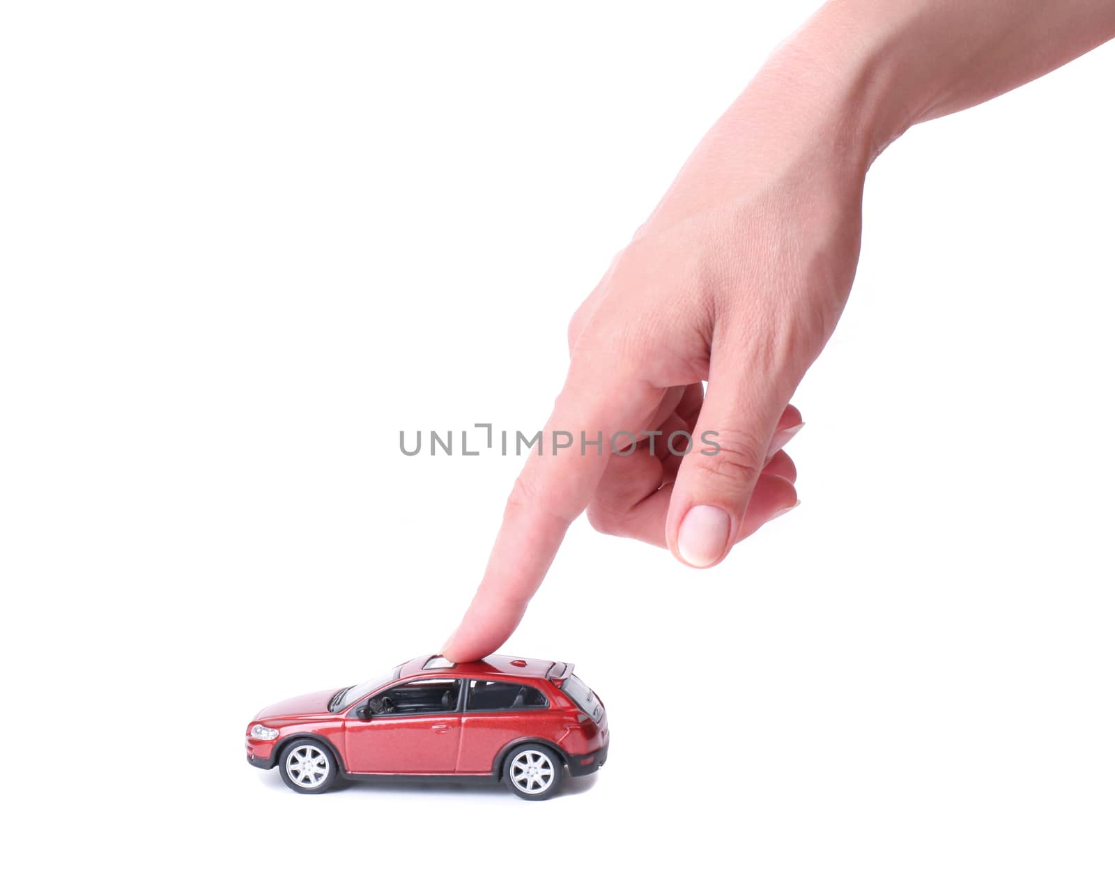 Female hand and the red toy car