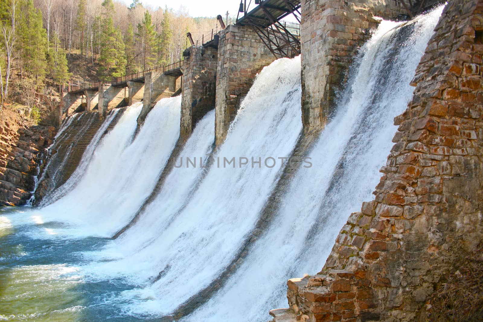 Old working hydroelectric power station on the river