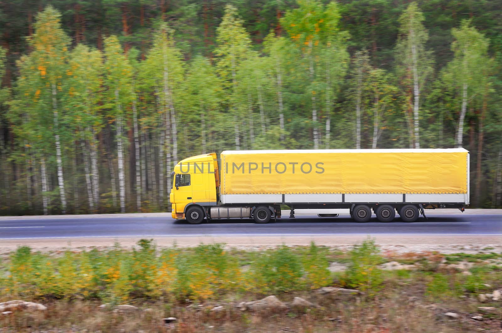 yellow trailer goes on highway by yurii_bizgaimer
