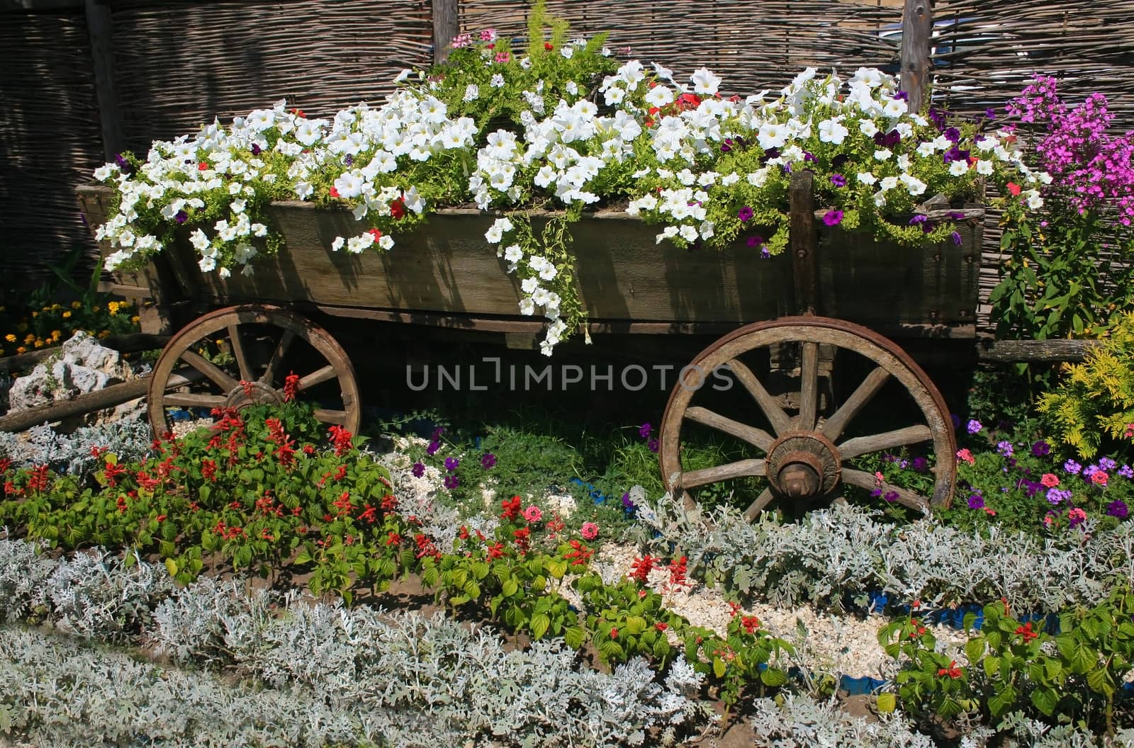 Bed  in the form of  cart filled with flowers