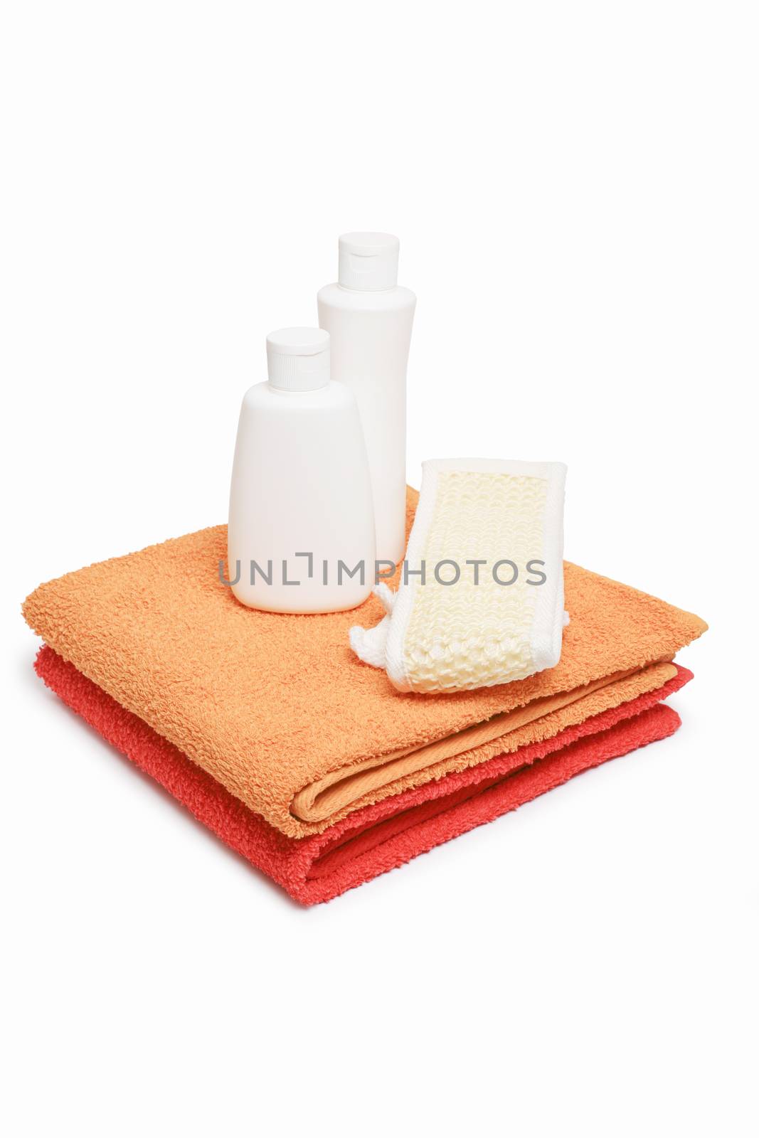 Towels bast and shampoo on white background