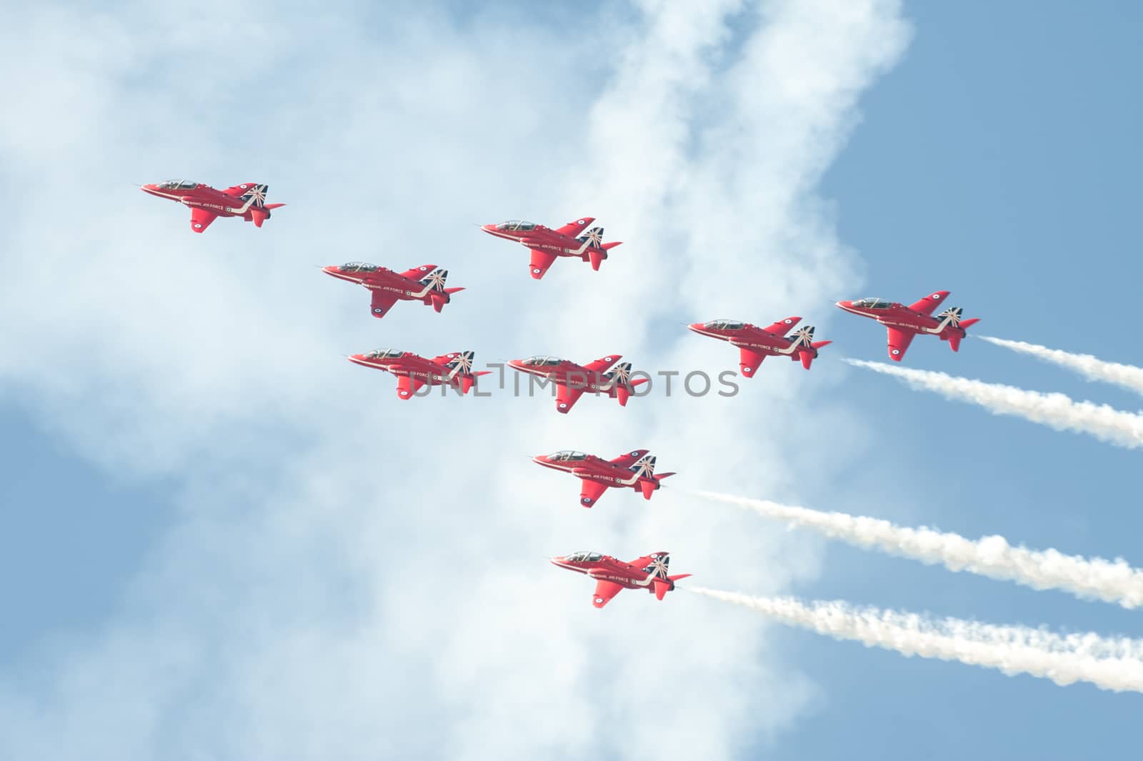 Farnborough, UK - July 18, 2014: The Red Arrows formation aerobatic display team leaving smoke trails in the sky over Farnborough, UK