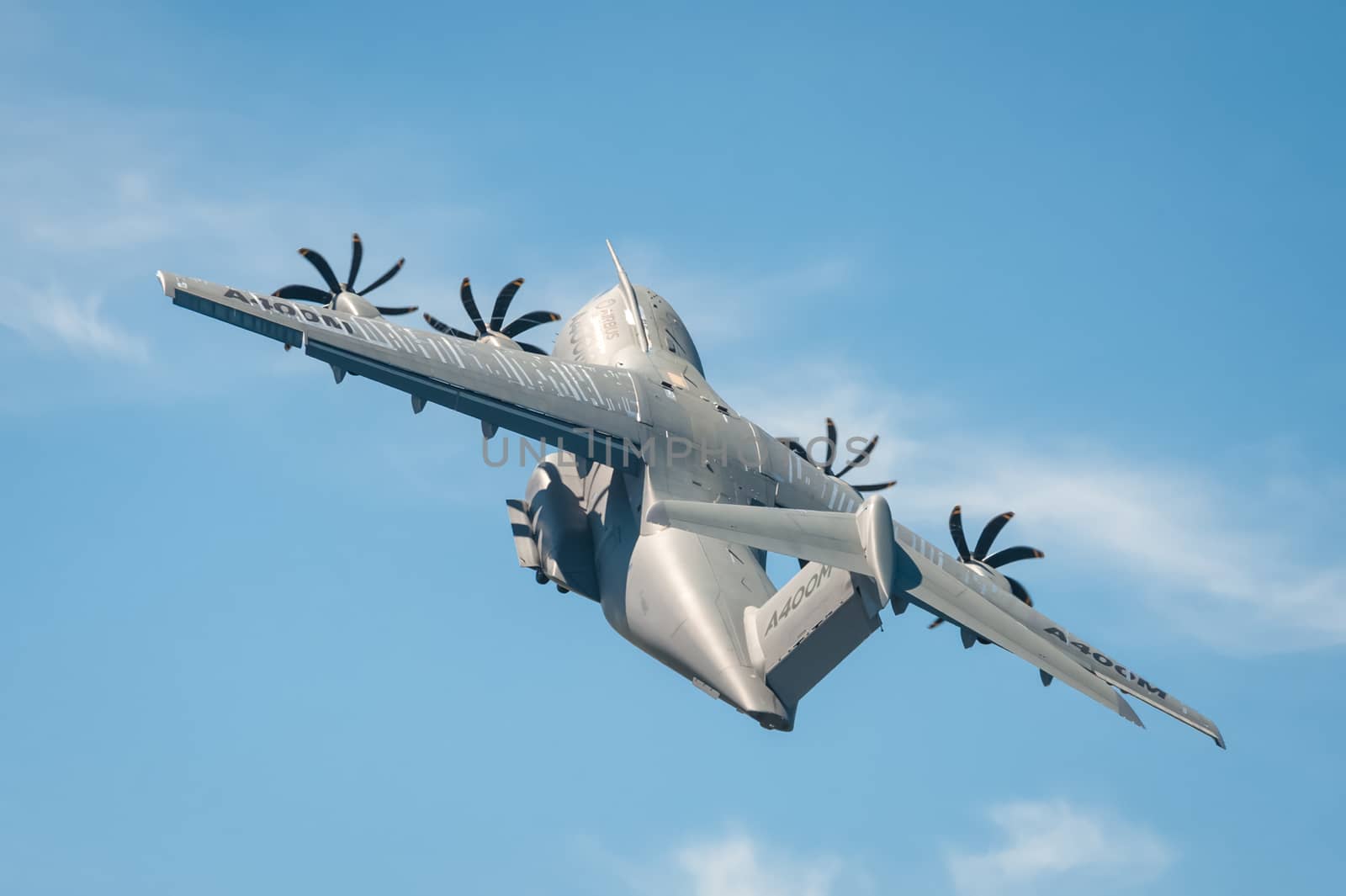 Farnborough, UK - July 18, 2014: Closeup of an Airbus A400M military transporter aircraft in a steep climb after take-off from Farnborough, Hampshire, UK