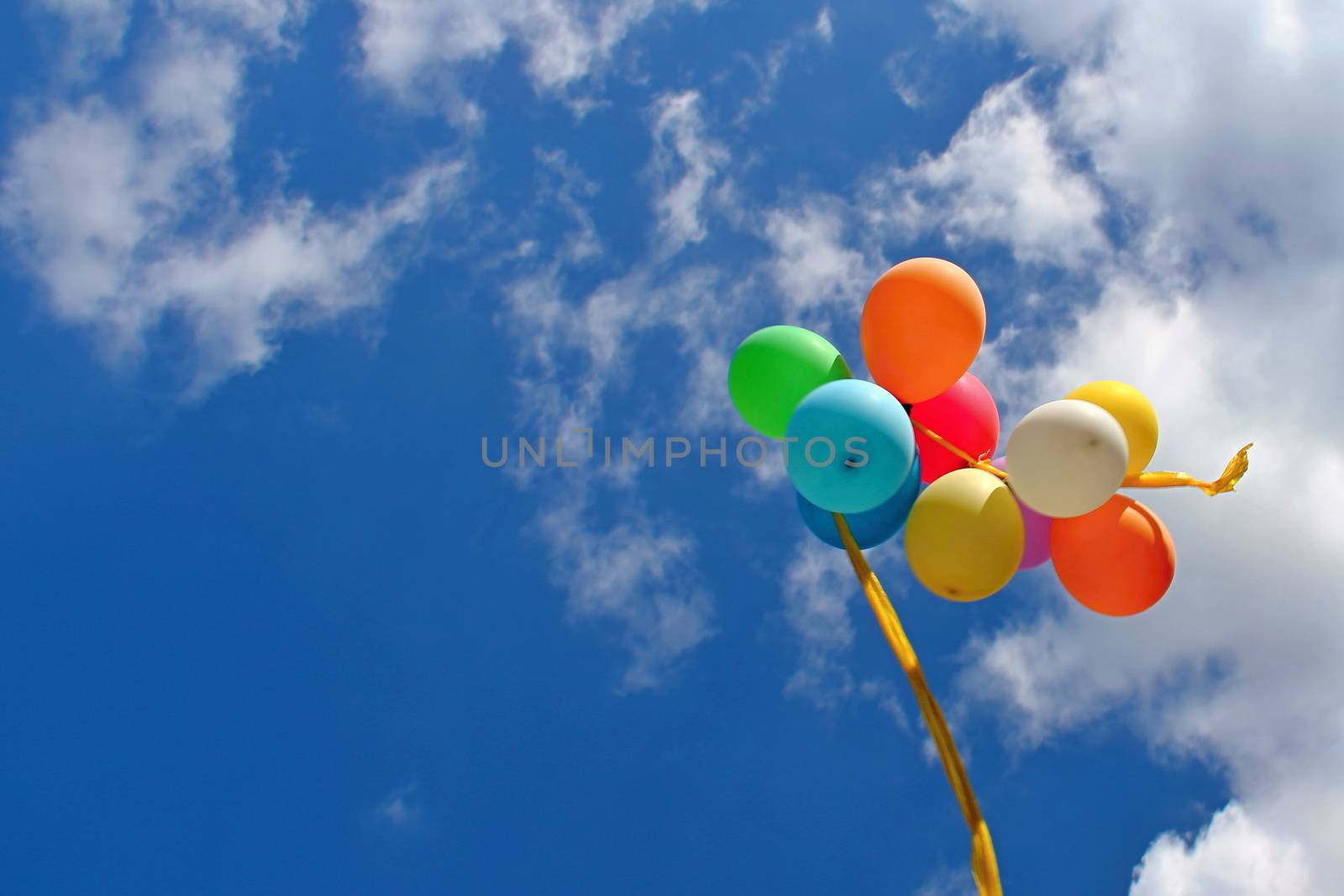 Photo shows colourful balloons in the sky.