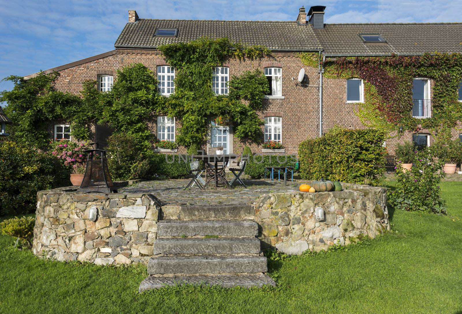 old farmers place with terrace from old rocks with chairs and tables