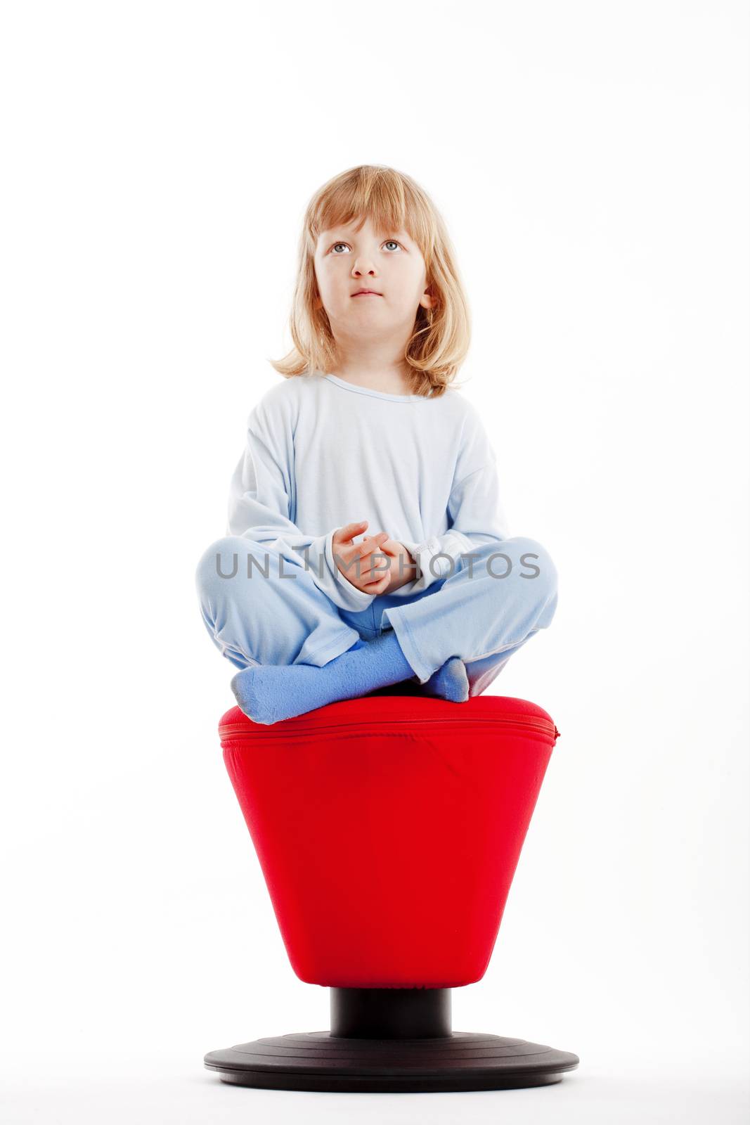 boy sitting on red stool by courtyardpix