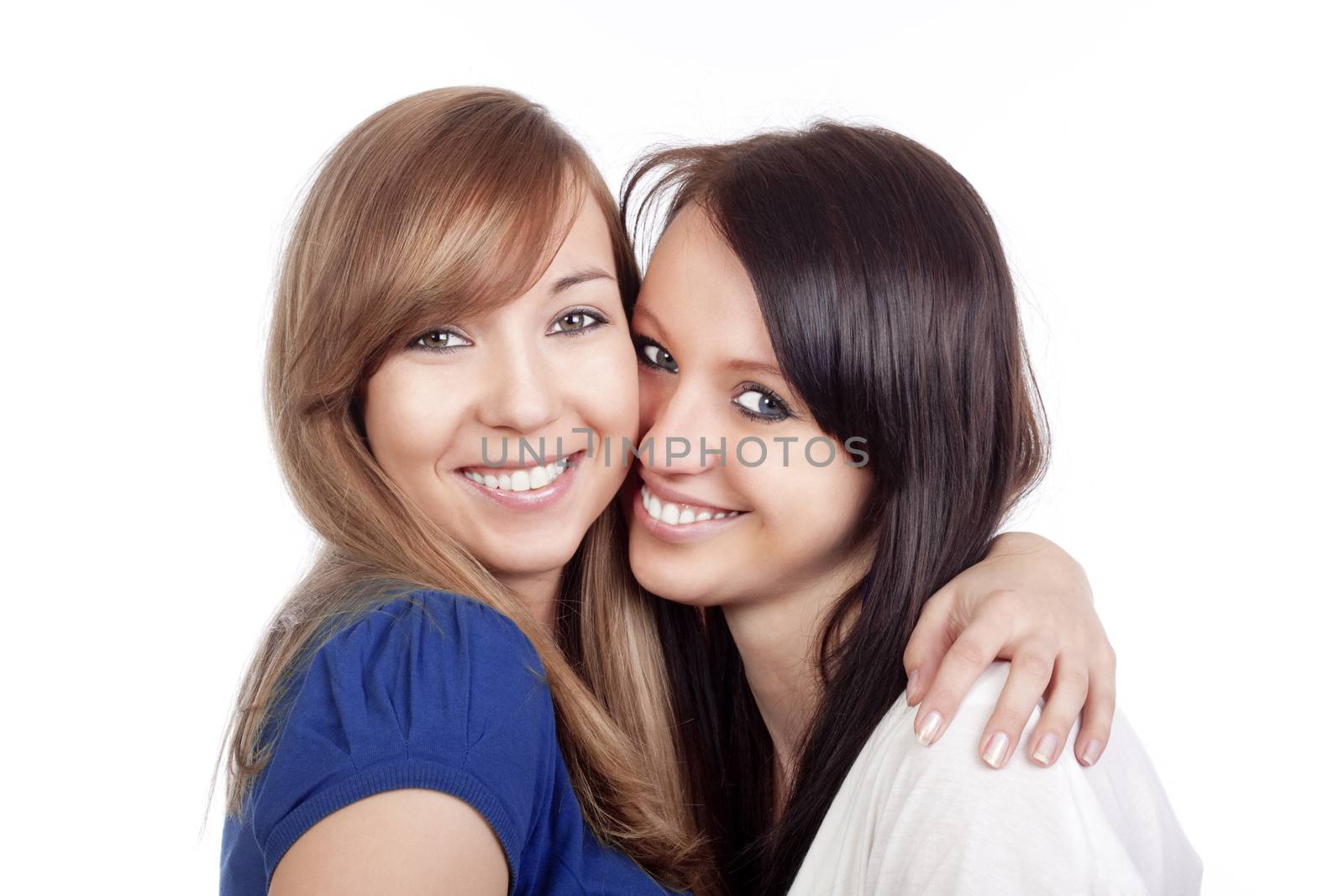 two happy young women standing, smiling - isolated on white