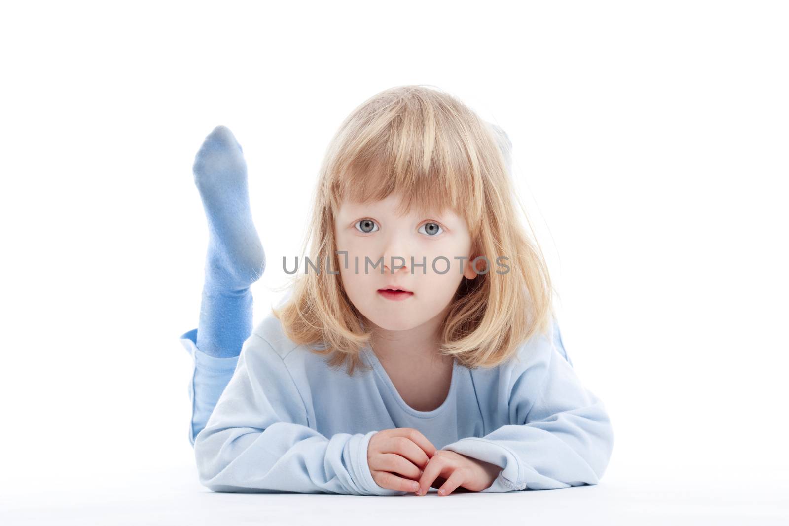 boy with long blond hair on the floor, looking at camera - isolated on white