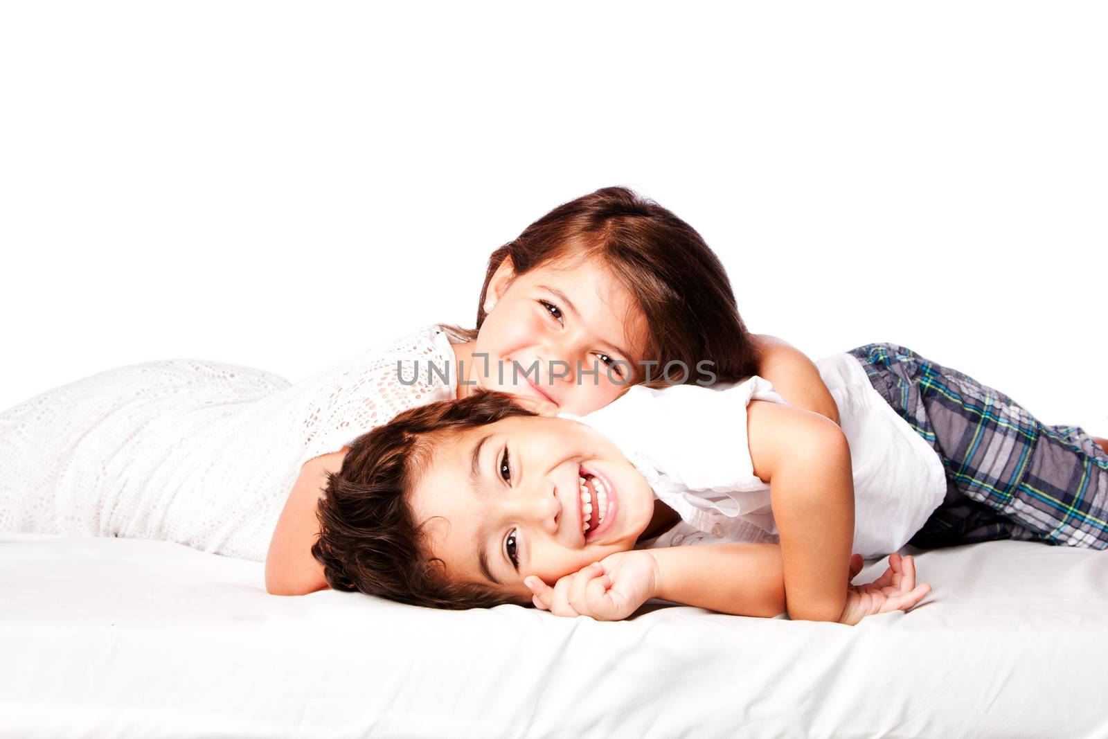 Happy smiling siblings brother sister together laying.