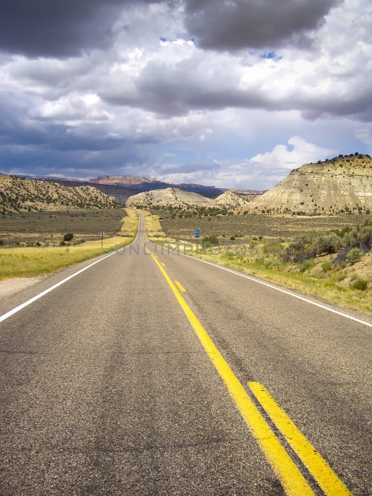 Utah roadway with sandstone formations in a storm