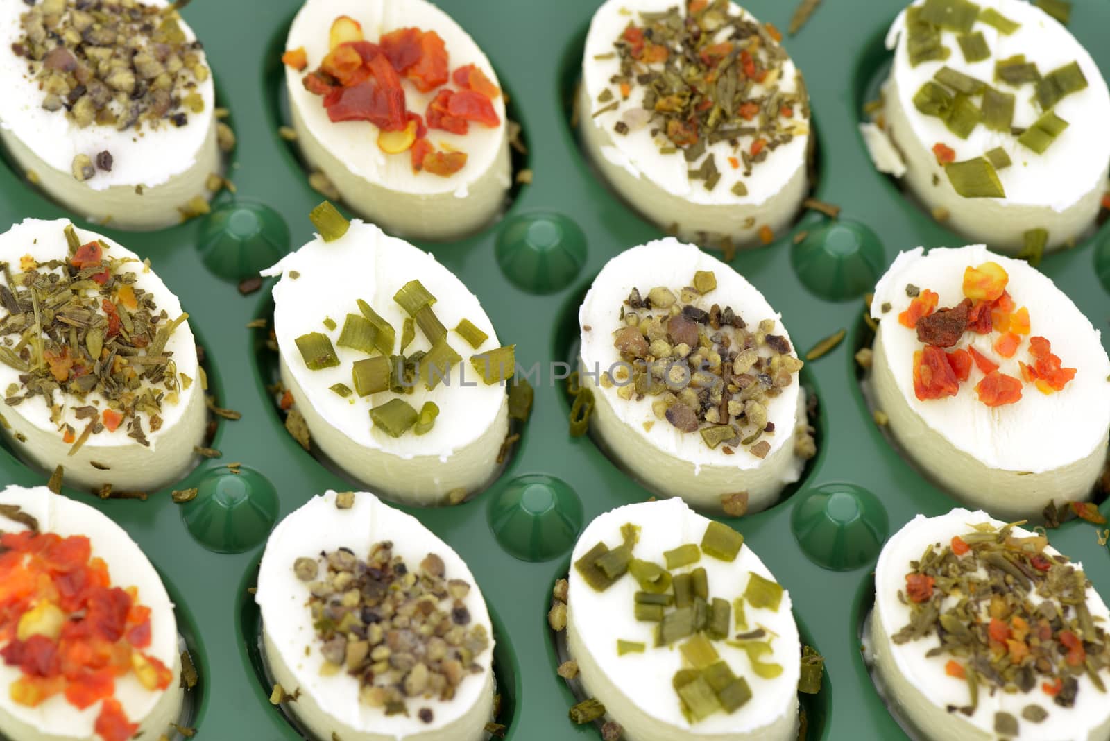 Close-up of cheese appetizers decorated with spices and vegetable