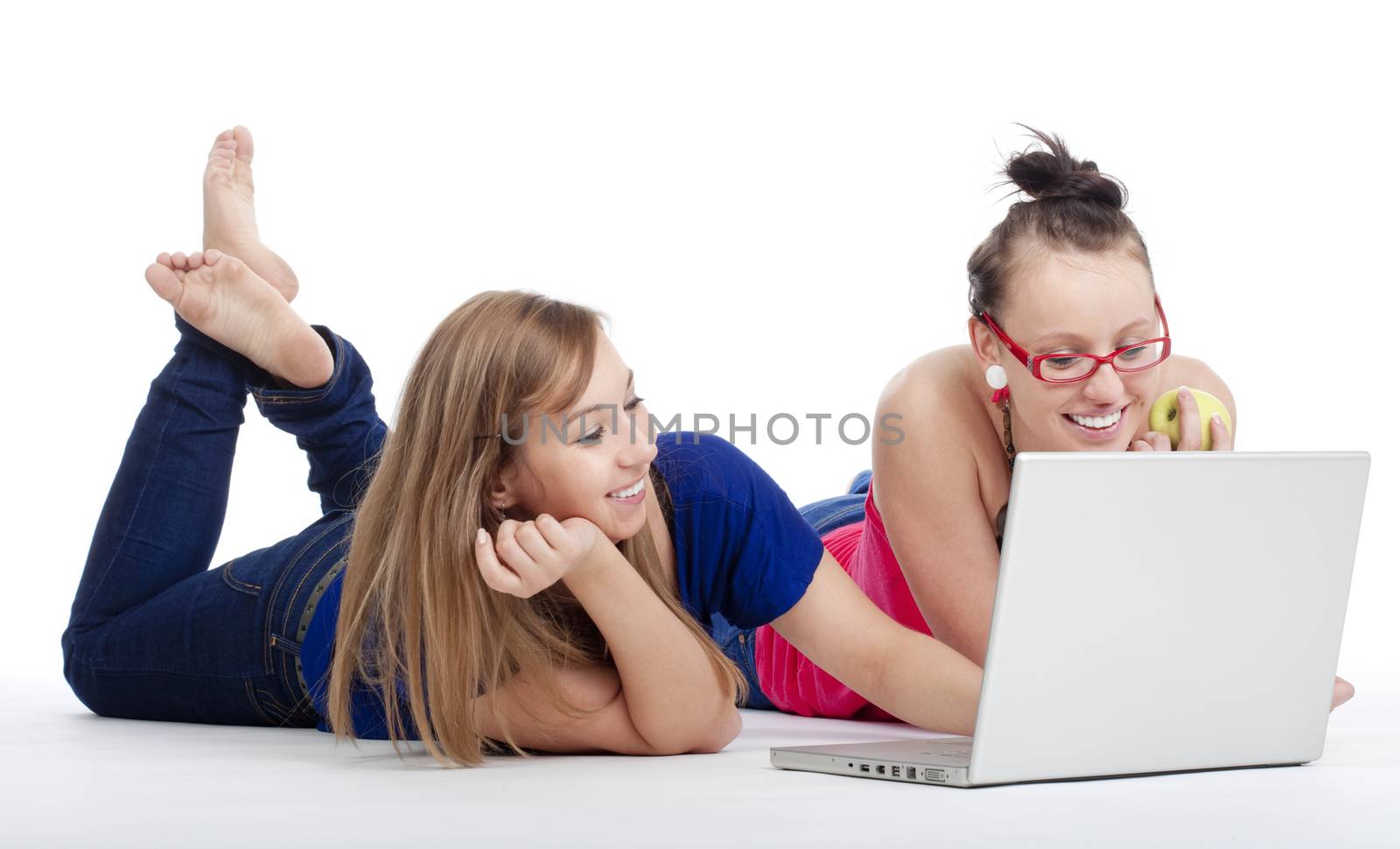 two young female friends having fun with laptop computer