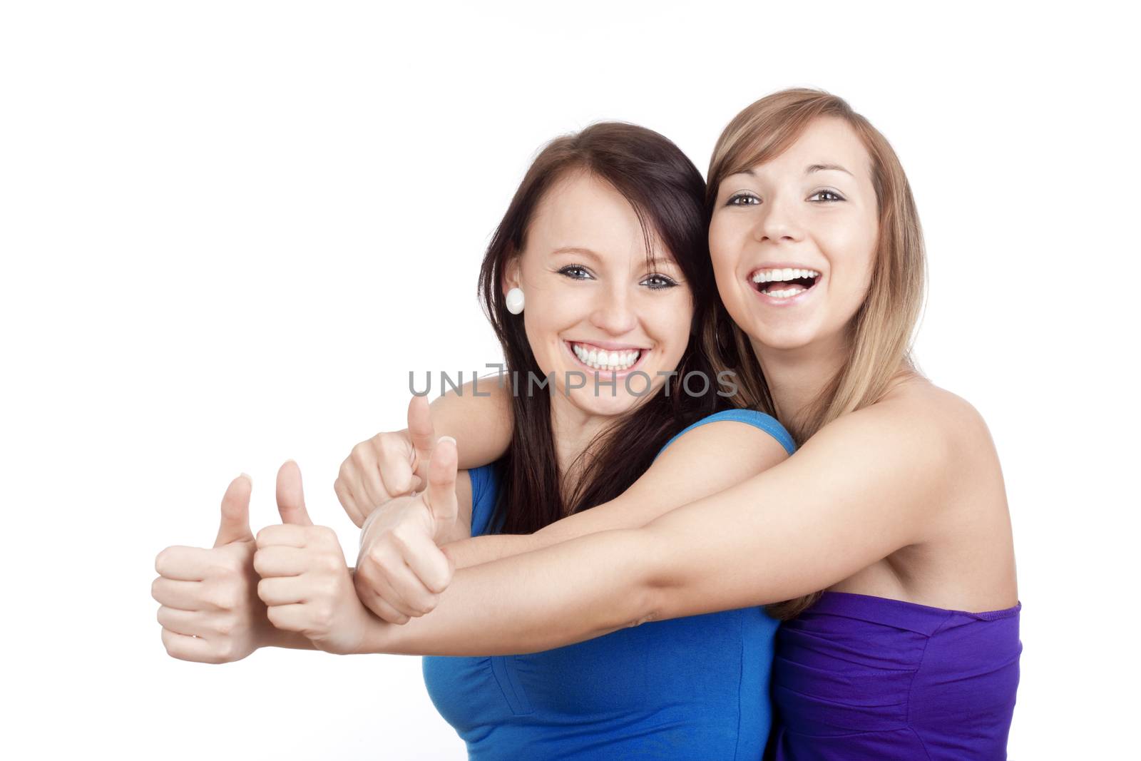 two young women showing thumbs up, smiling - isolated on white