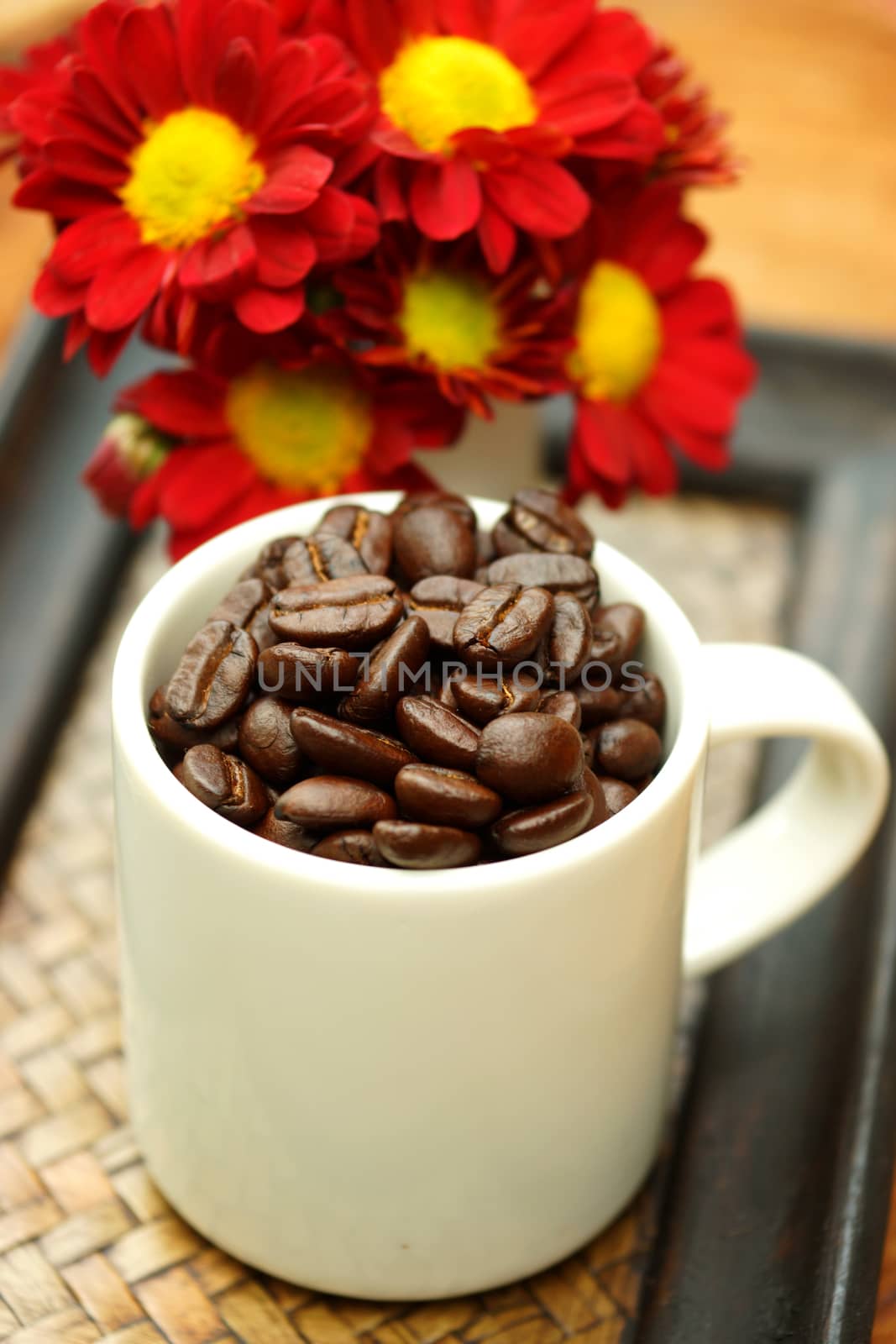 Coffee bean in cup on Bamboo tray.