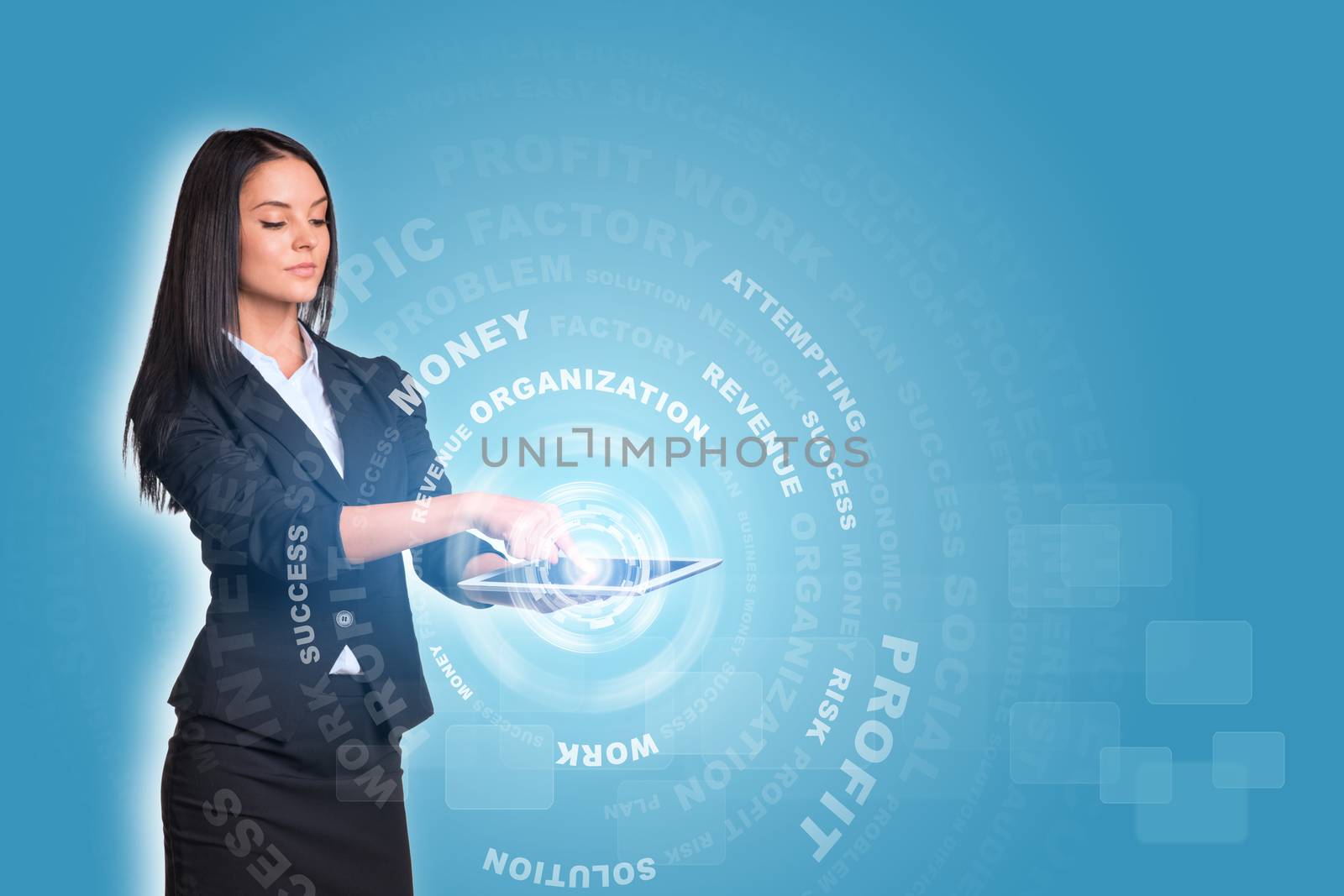 Beautiful businesswomen in suit using digital tablet. Glow circles with business words