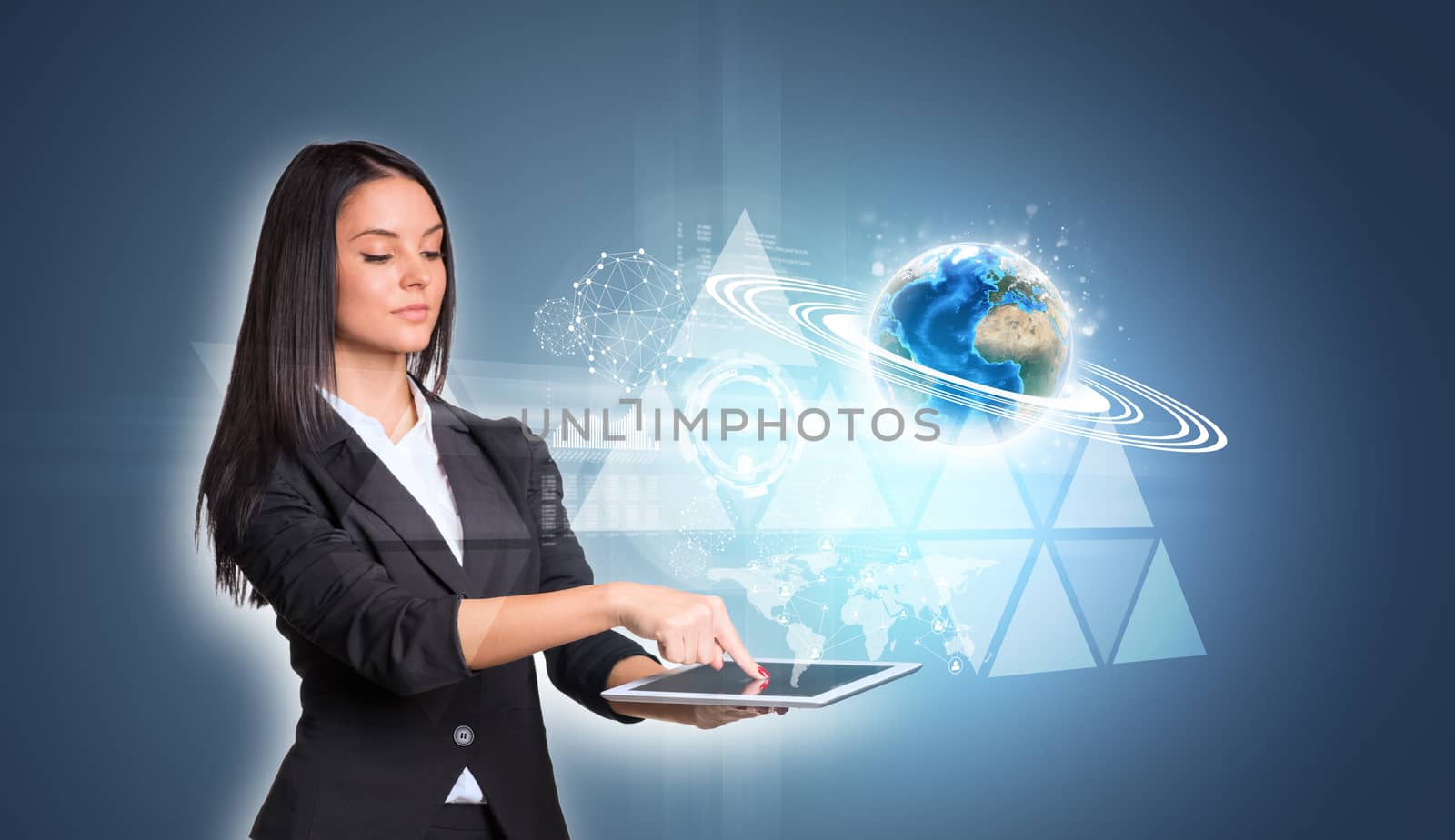 Beautiful businesswomen in suit using digital tablet. Earth with triangles and network. Element of this image furnished by NASA
