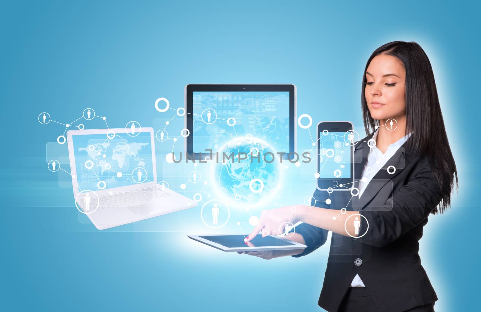 Beautiful businesswomen in suit using digital tablet. Earth with laptop, tablets and smartphone. Element of this image furnished by NASA