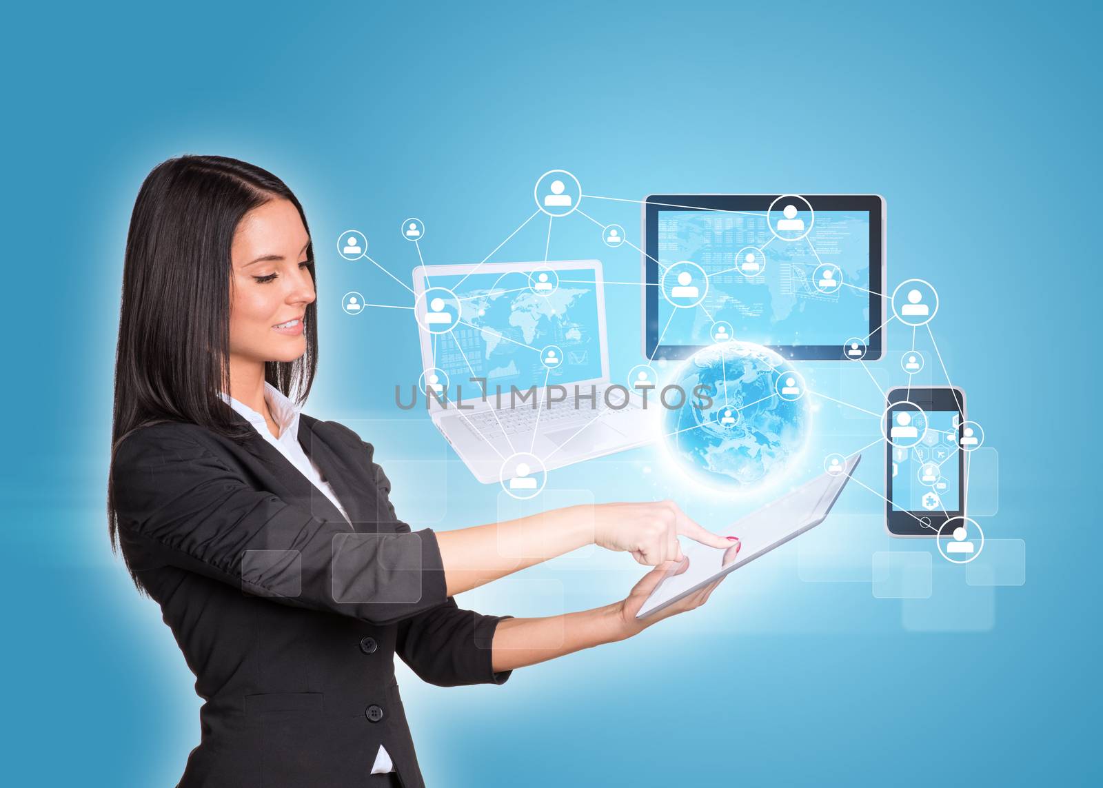 Beautiful businesswomen in suit using digital tablet. Earth with laptop, tablets and smartphone. Element of this image furnished by NASA