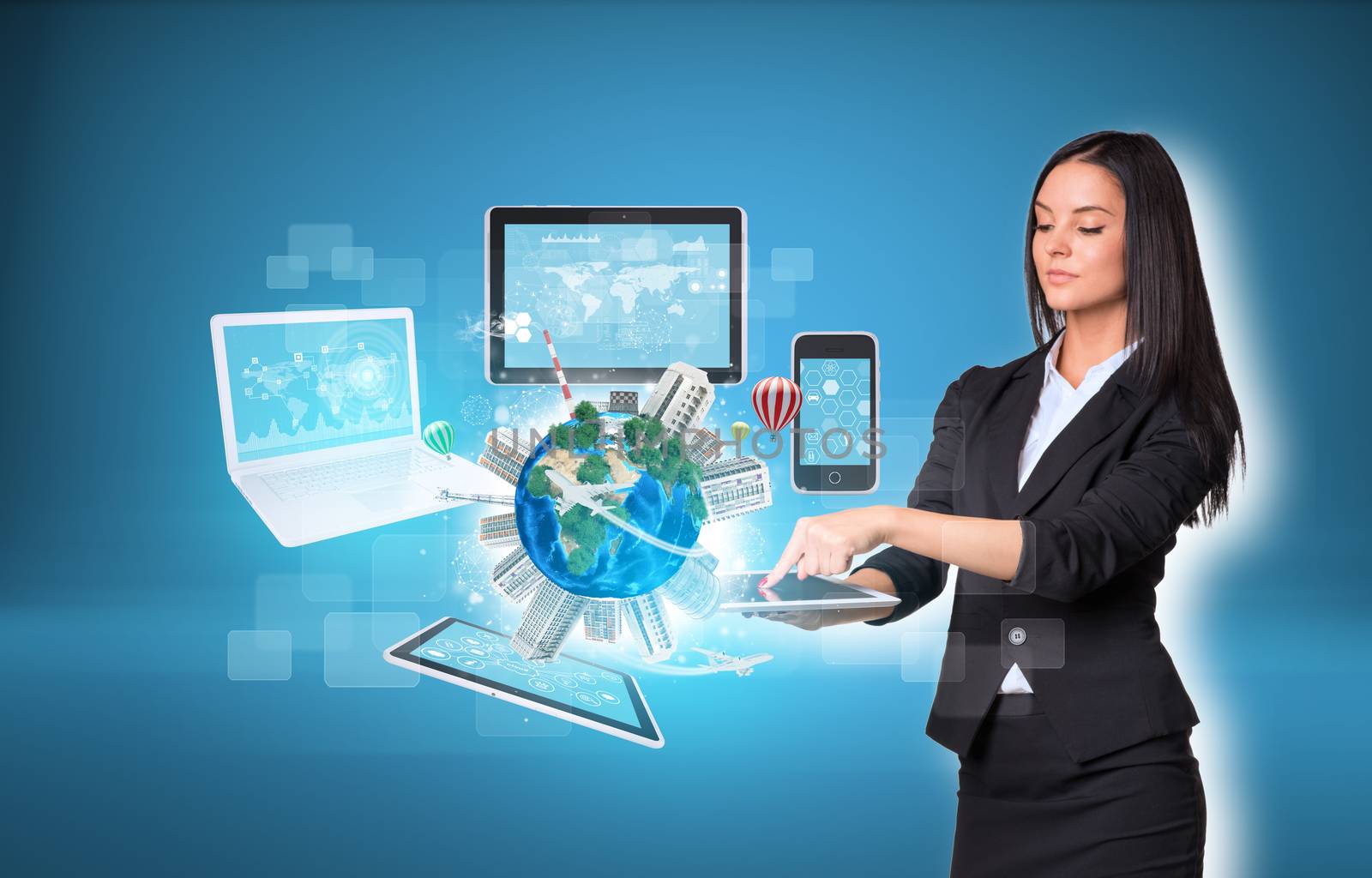 Beautiful businesswomen in suit using digital tablet. Earth with buildings and laptop, tablets and smartphone. Element of this image furnished by NASA