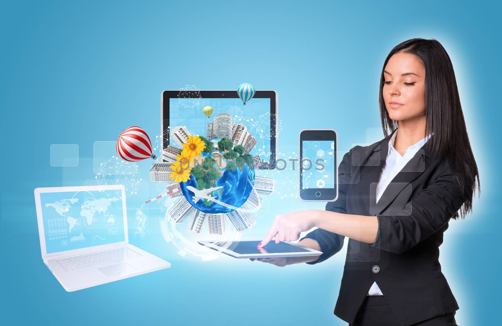 Beautiful businesswomen in suit using digital tablet. Earth with buildings and laptop, tablet and smartphone. Element of this image furnished by NASA
